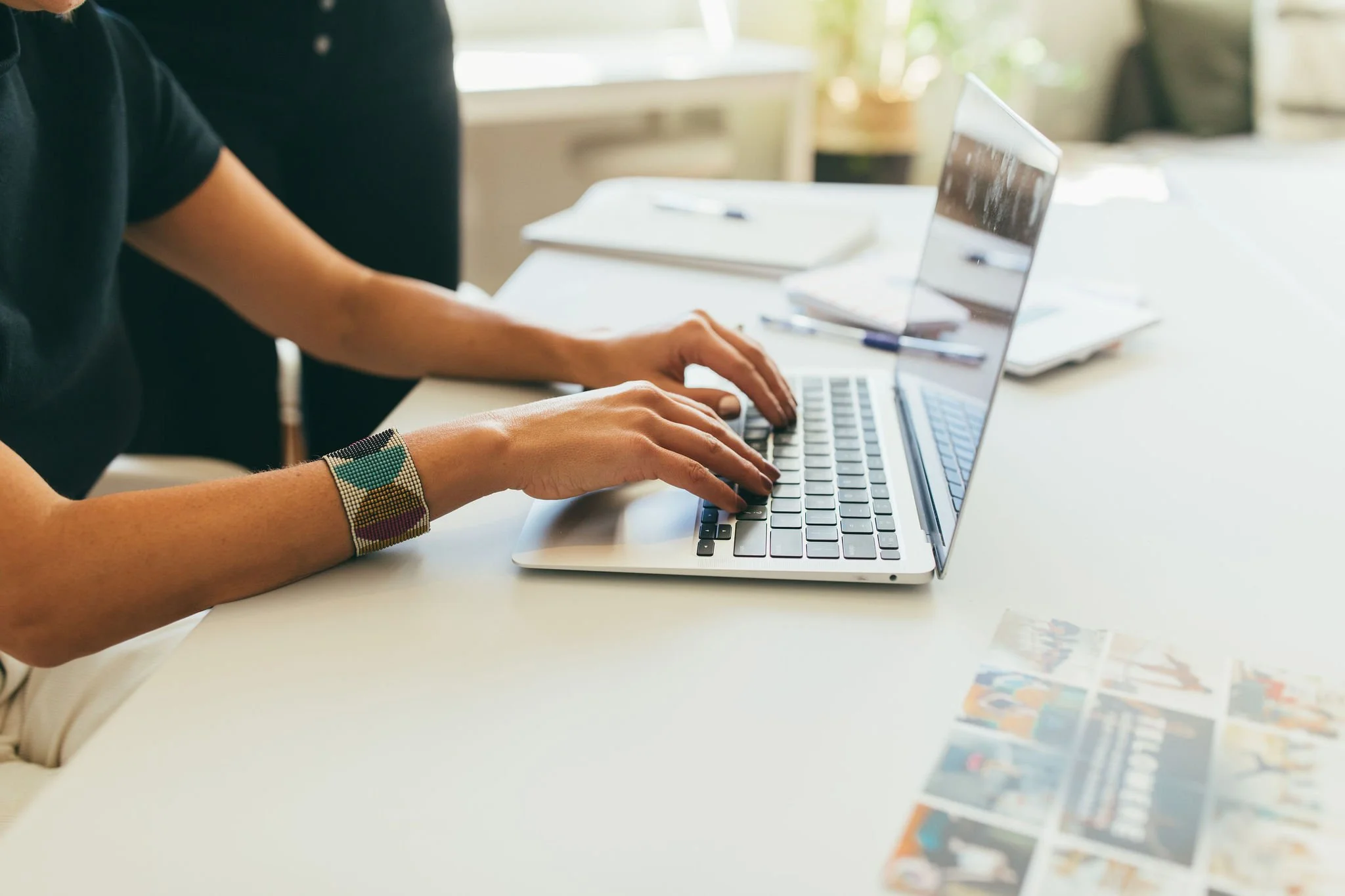 A woman typing in her computer as she works in email marketing campaigns