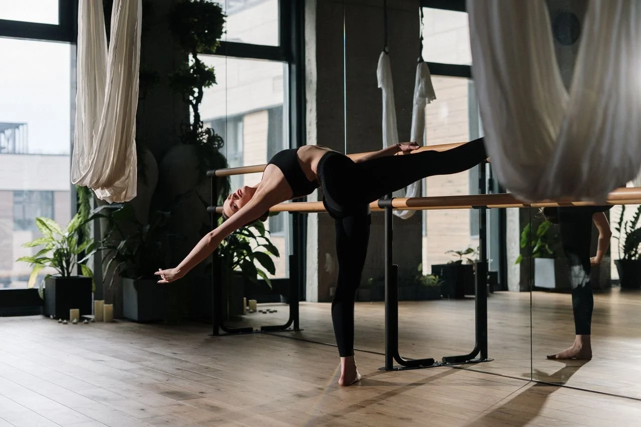 woman stretching during a barre fitness class