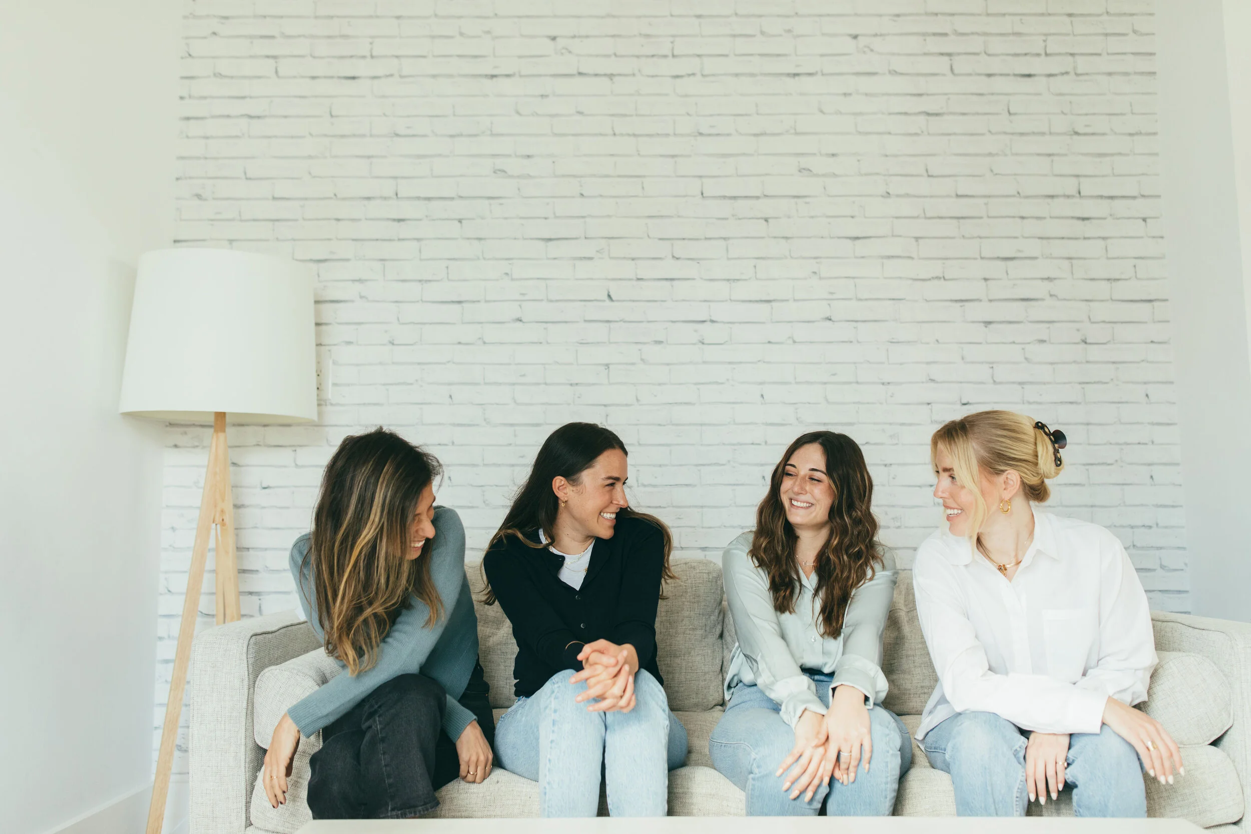 Catalina Zbar, CEO of Telomere, sitting on a couch with the Telomere team