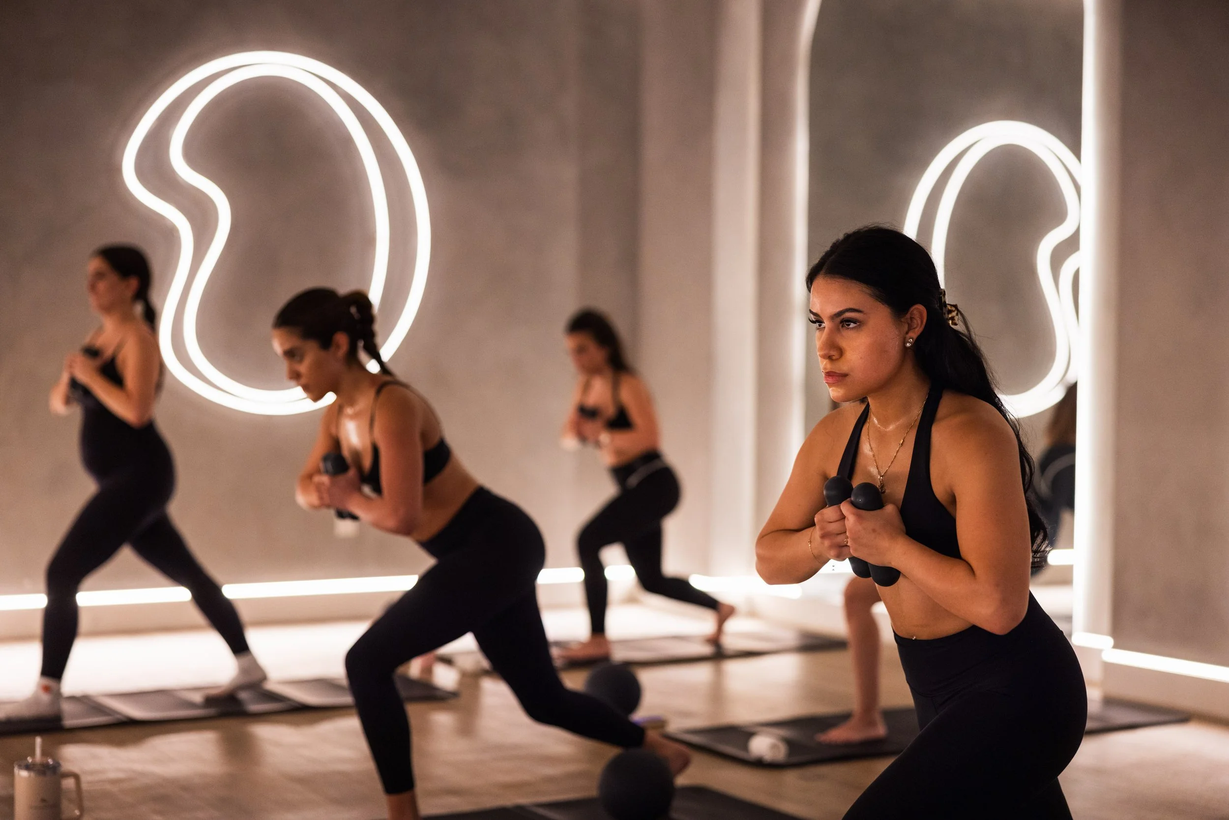 A group of women during a hot Pilates class