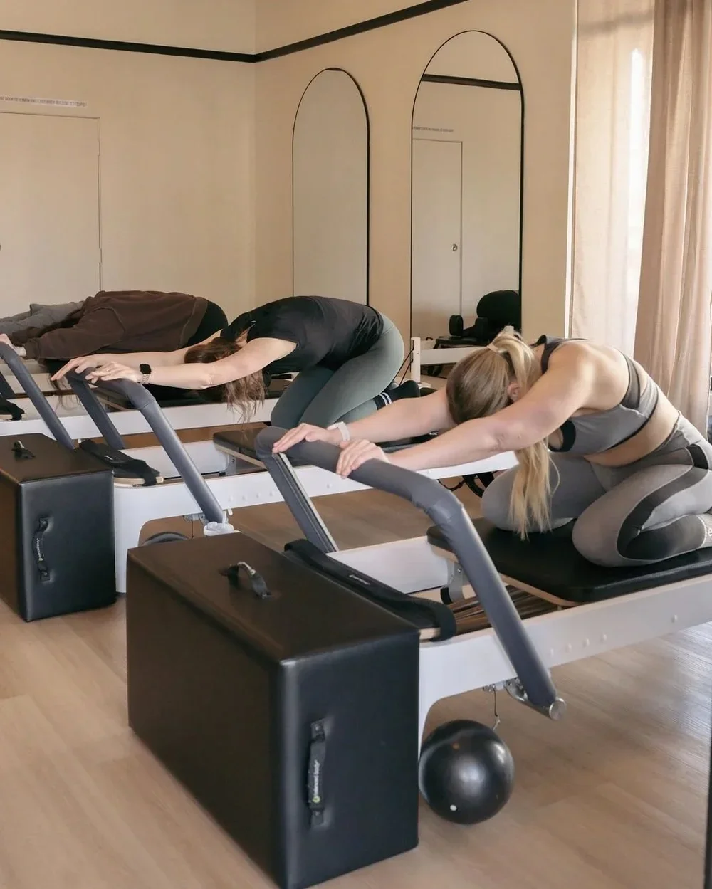 A group of women doing reformer Pilates