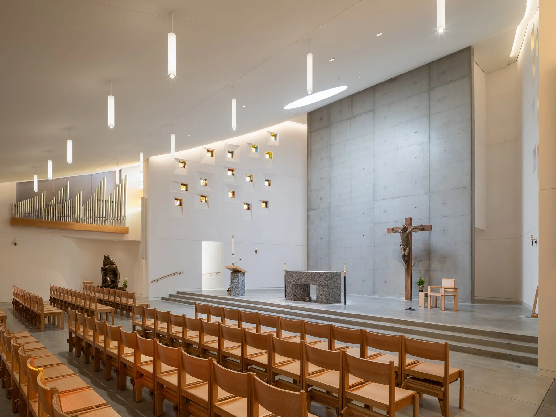 Chapel of the Risen Christ interior nave with pipe organ and Pieta, by Design Alliance Architects - architectural photographer St. Louis Missouri