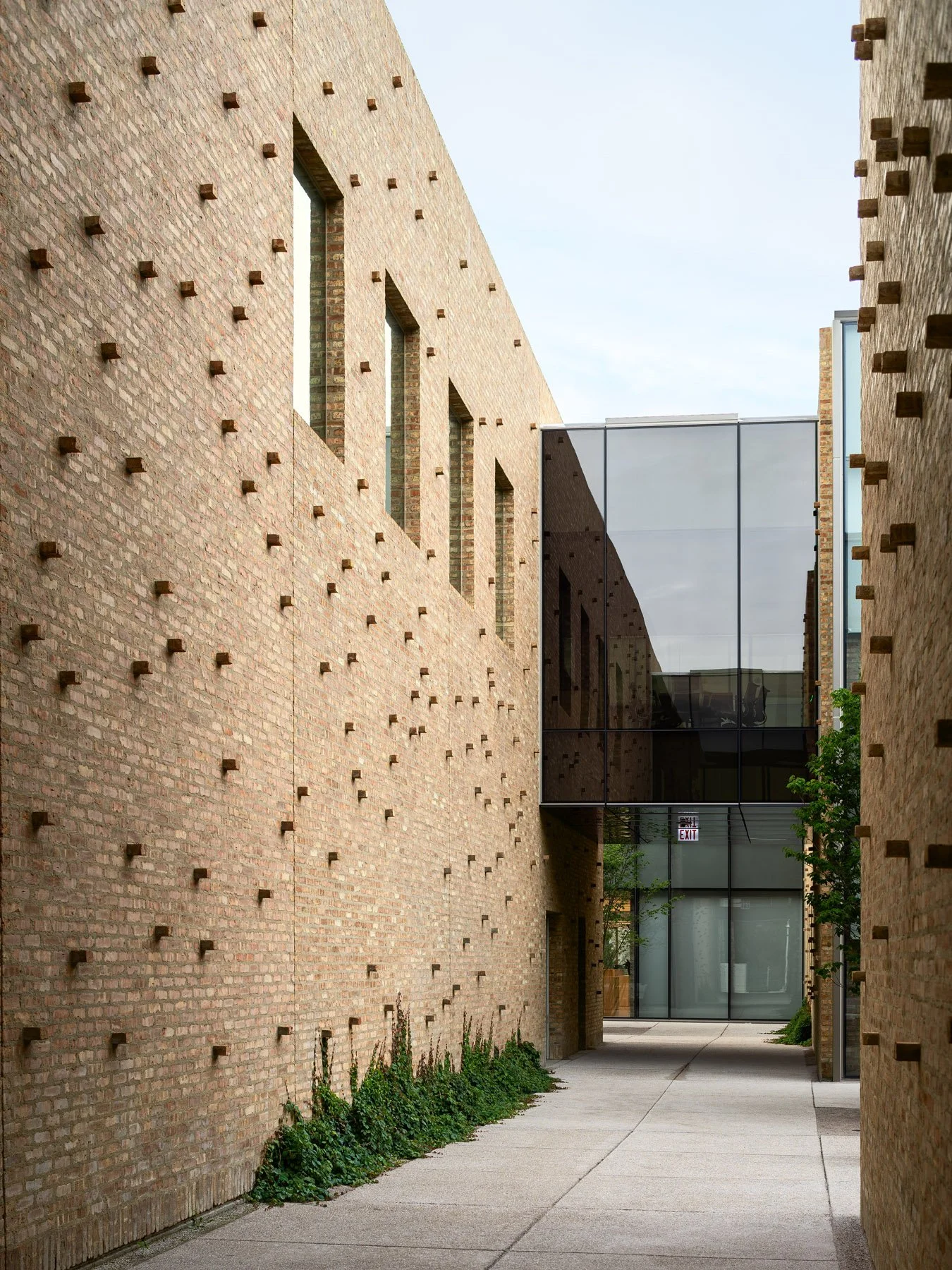 Chicago Park District HQ narrow passage between brick volumes with projecting brick relief and glazed connector, by John Ronan Architects - architectural photographer Chicago Illinois