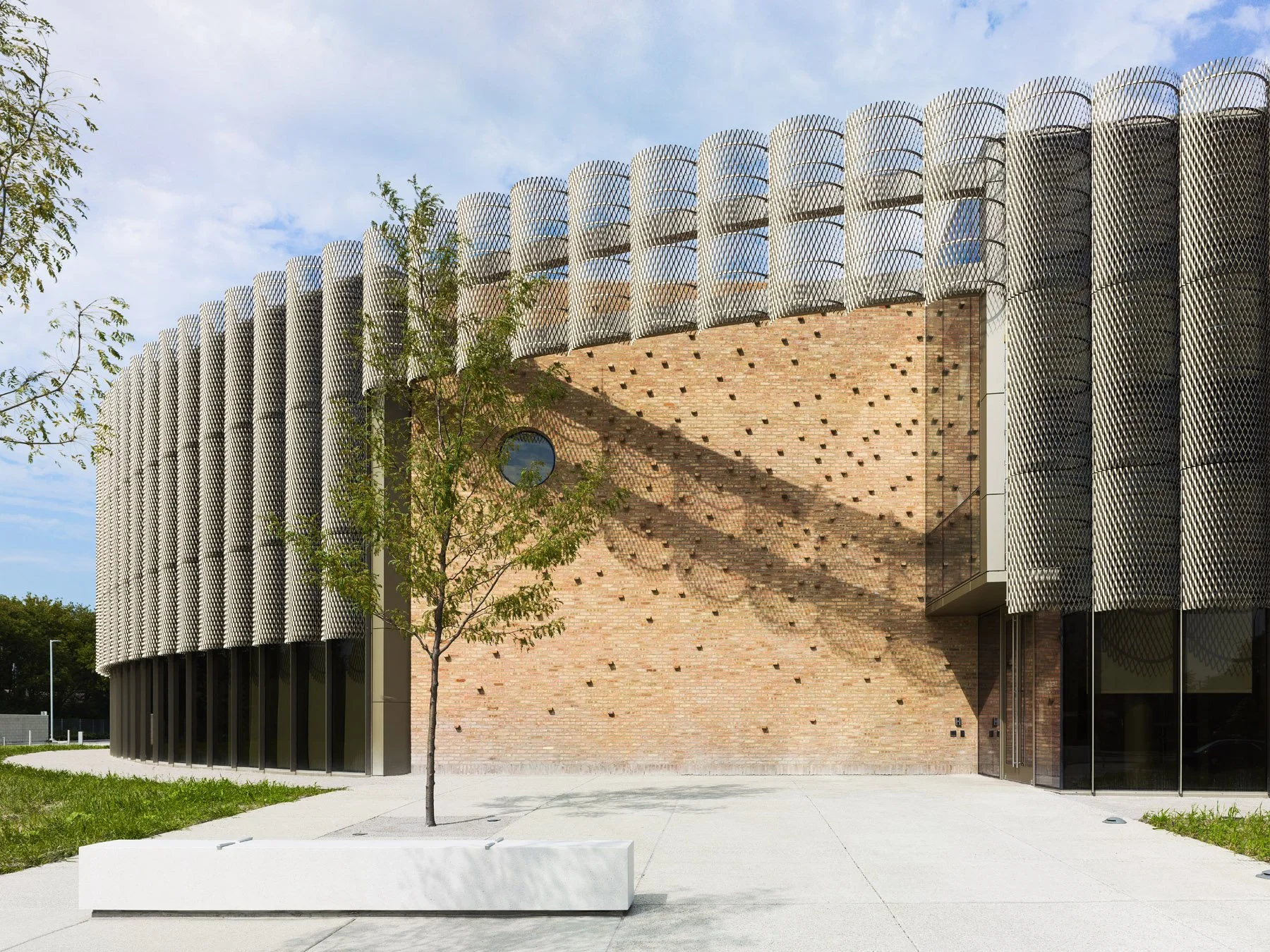 Chicago Park District HQ main entry courtyard, salvaged brick wall with relief pattern and marble bench, by John Ronan Architects - architectural photographer Chicago Illinois