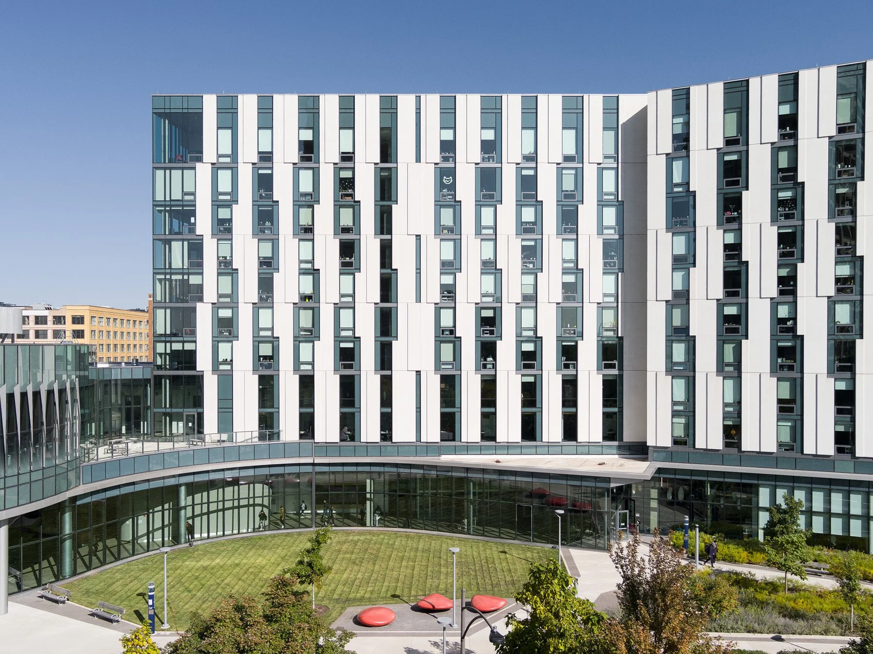 UIC Academic and Residential Complex curved glass base and courtyard lawn, by SCB - architectural photographer Chicago Illinois