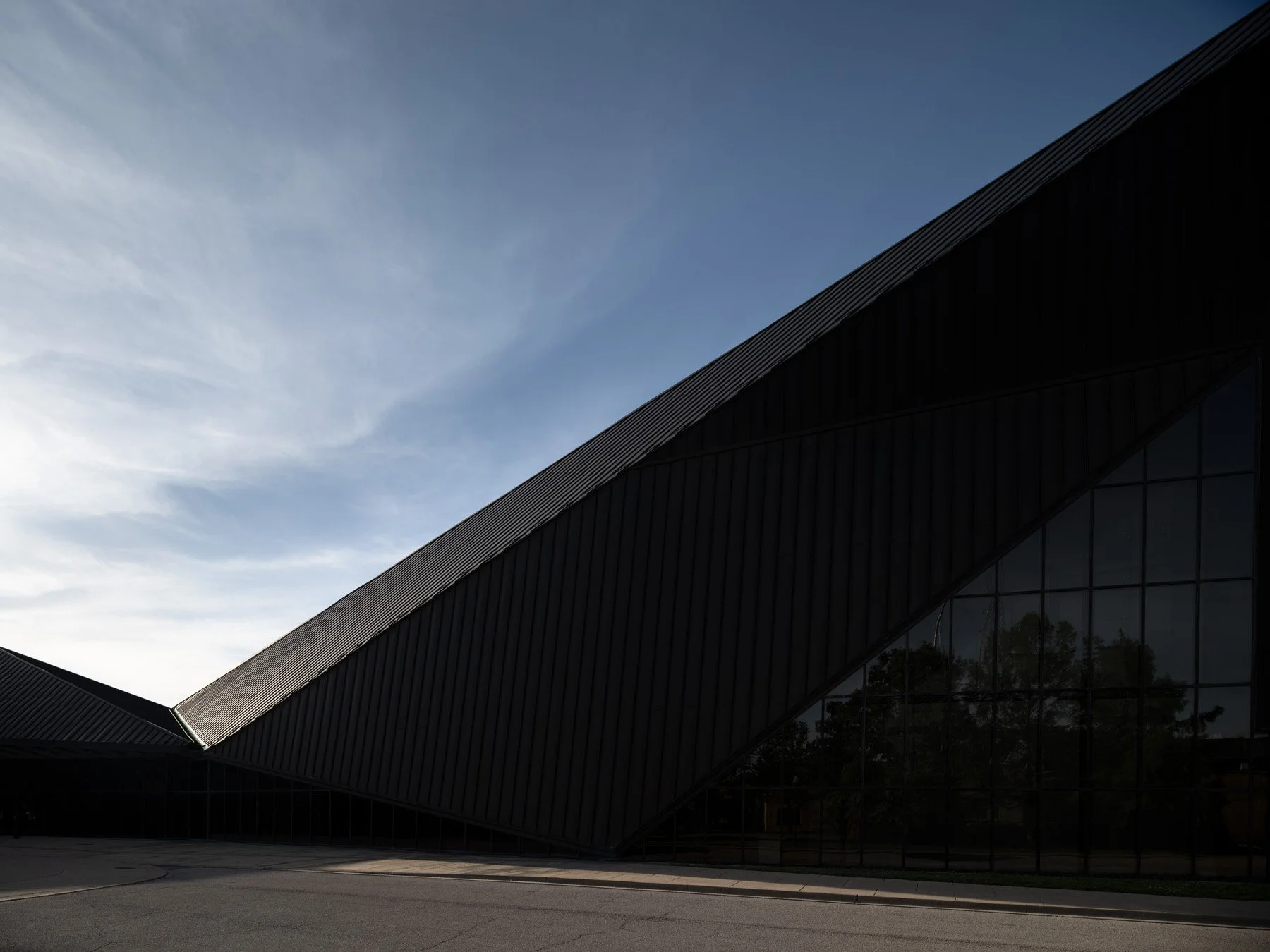 Doudna Fine Arts Center exterior canted copper roofline against the sky at dusk by Antoine Predock, Charleston Illinois - architectural photographer