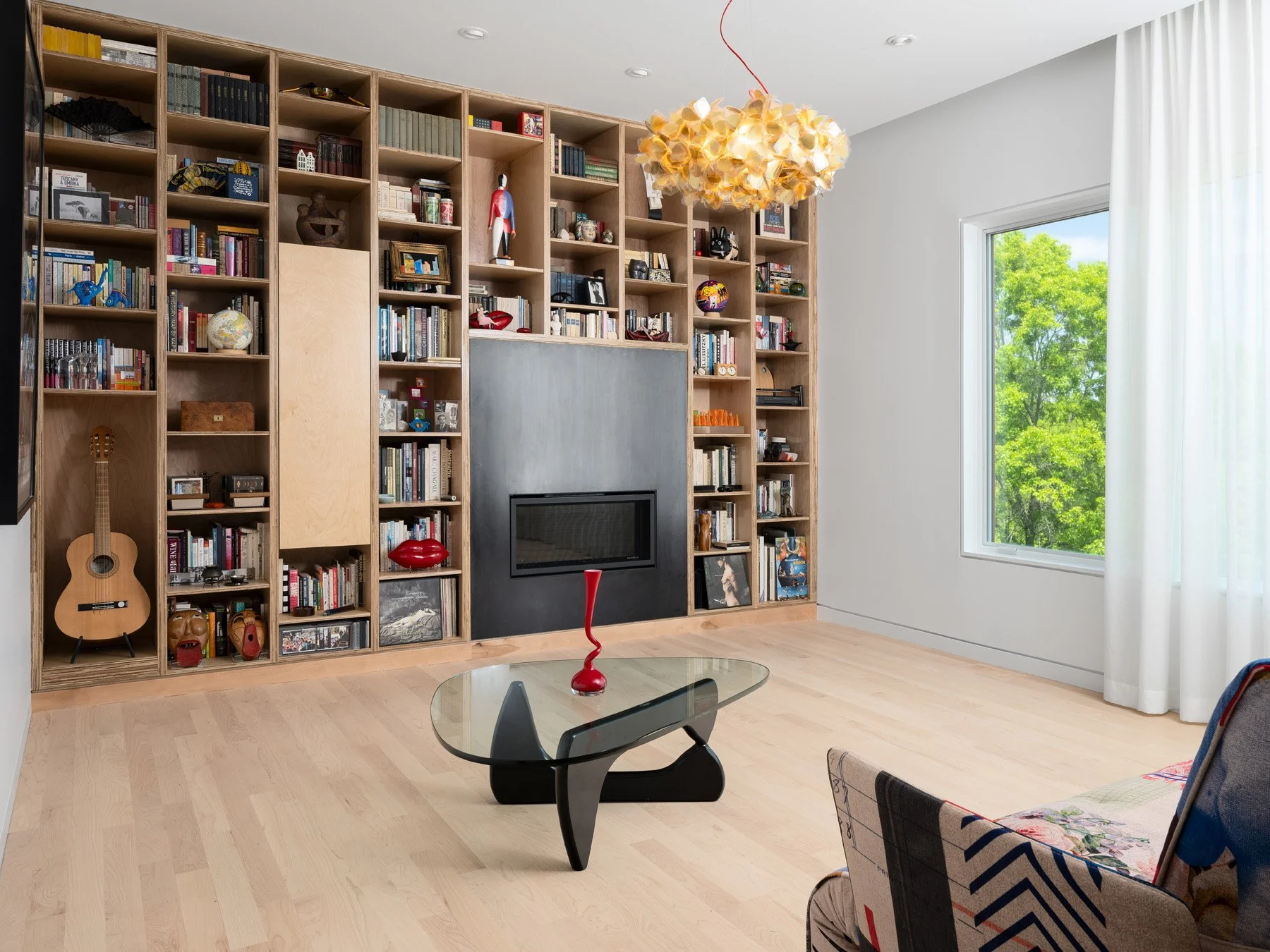 Monty Residence interior living room with plywood shelving and a steel fireplace, by Studio Lark - architectural photographer St. Louis Missouri