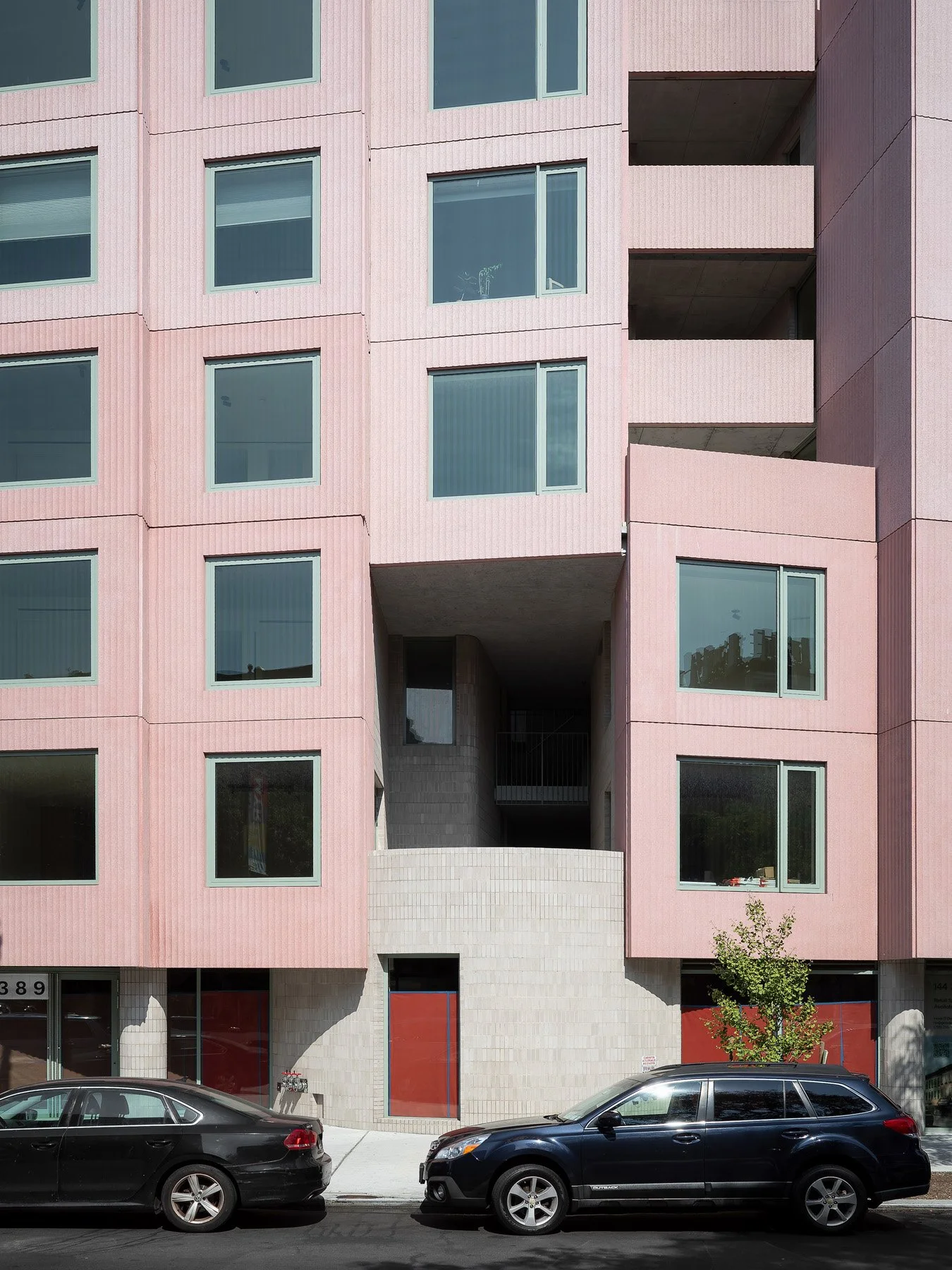 144 Vanderbilt stepped pink facade over a white-tiled base with red entry doors, by SO-IL, Brooklyn - architectural photographer New York