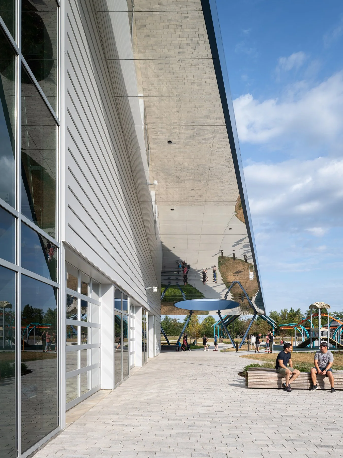 Kinetic Park mirrored stainless roof soffit cantilevered over the entry walk, by JEMA - architectural photographer St. Louis Missouri