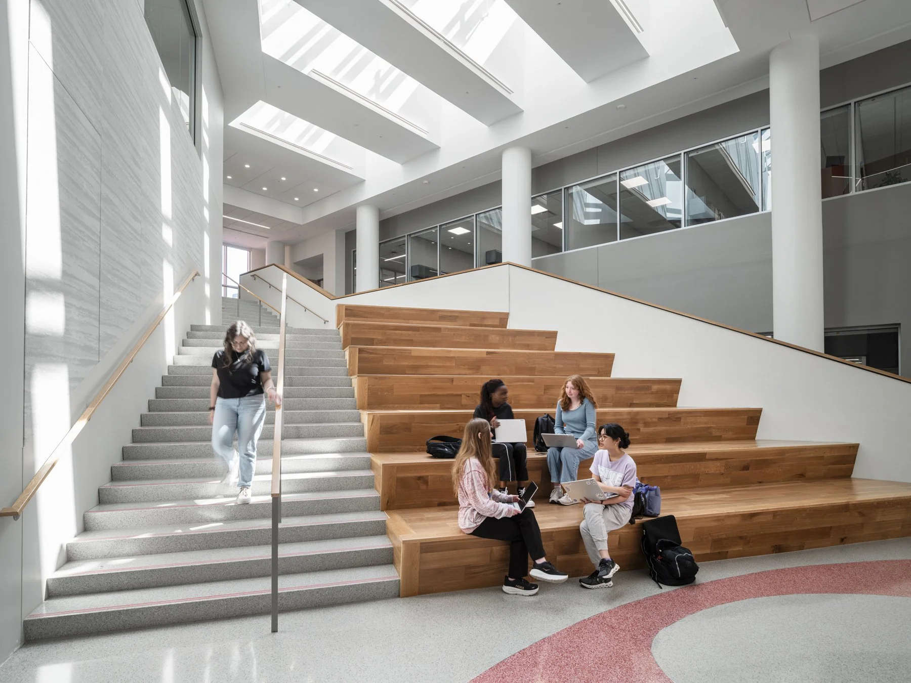SIUE Health Sciences wood bleacher stair below skylights with students studying by Christner, Edwardsville Illinois - architectural photographer St. Louis