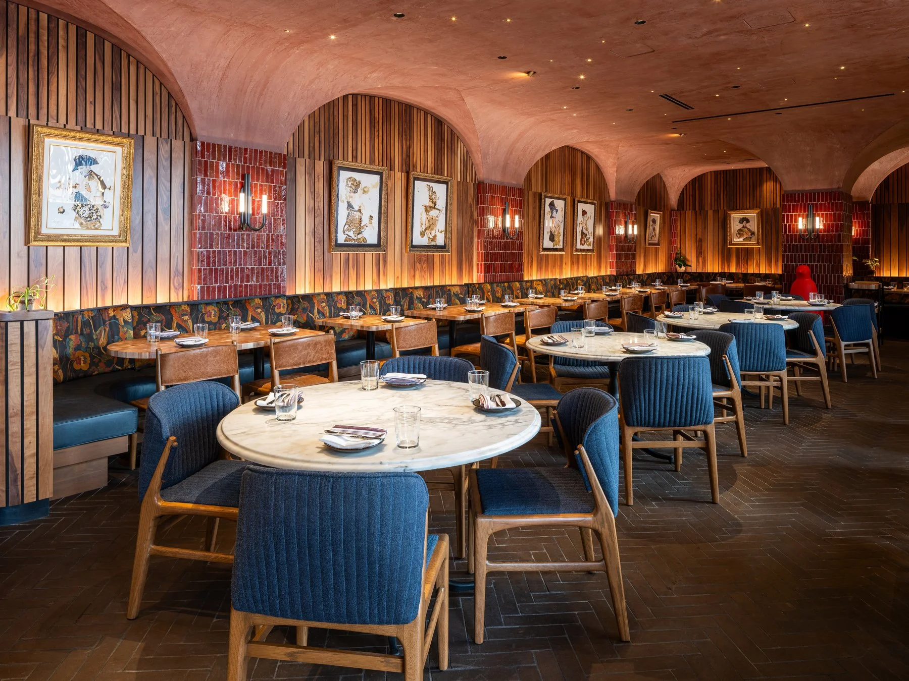 Idol Wolf restaurant interior dining room beneath a vaulted pink plaster ceiling with red tile and wood slat walls, at the 21c Museum Hotel by Perfido Weiskopf Wagstaff + Goettel and Hufft - architectural photographer St. Louis Missouri
