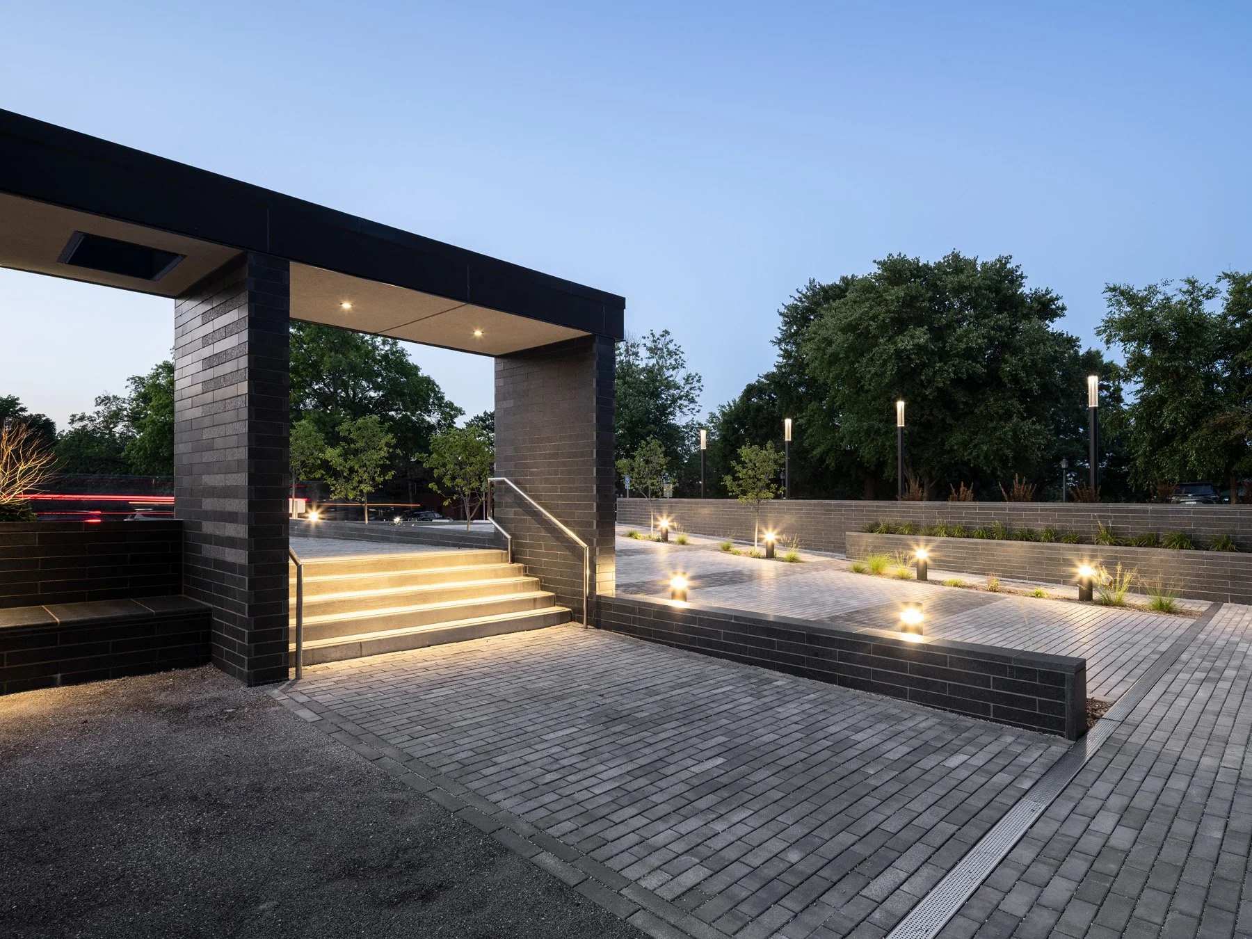 Des Peres City Hall entry pavilion at dusk with illuminated steps and terraced plaza by Patterhn Ives, Des Peres Missouri - architectural photographer St. Louis