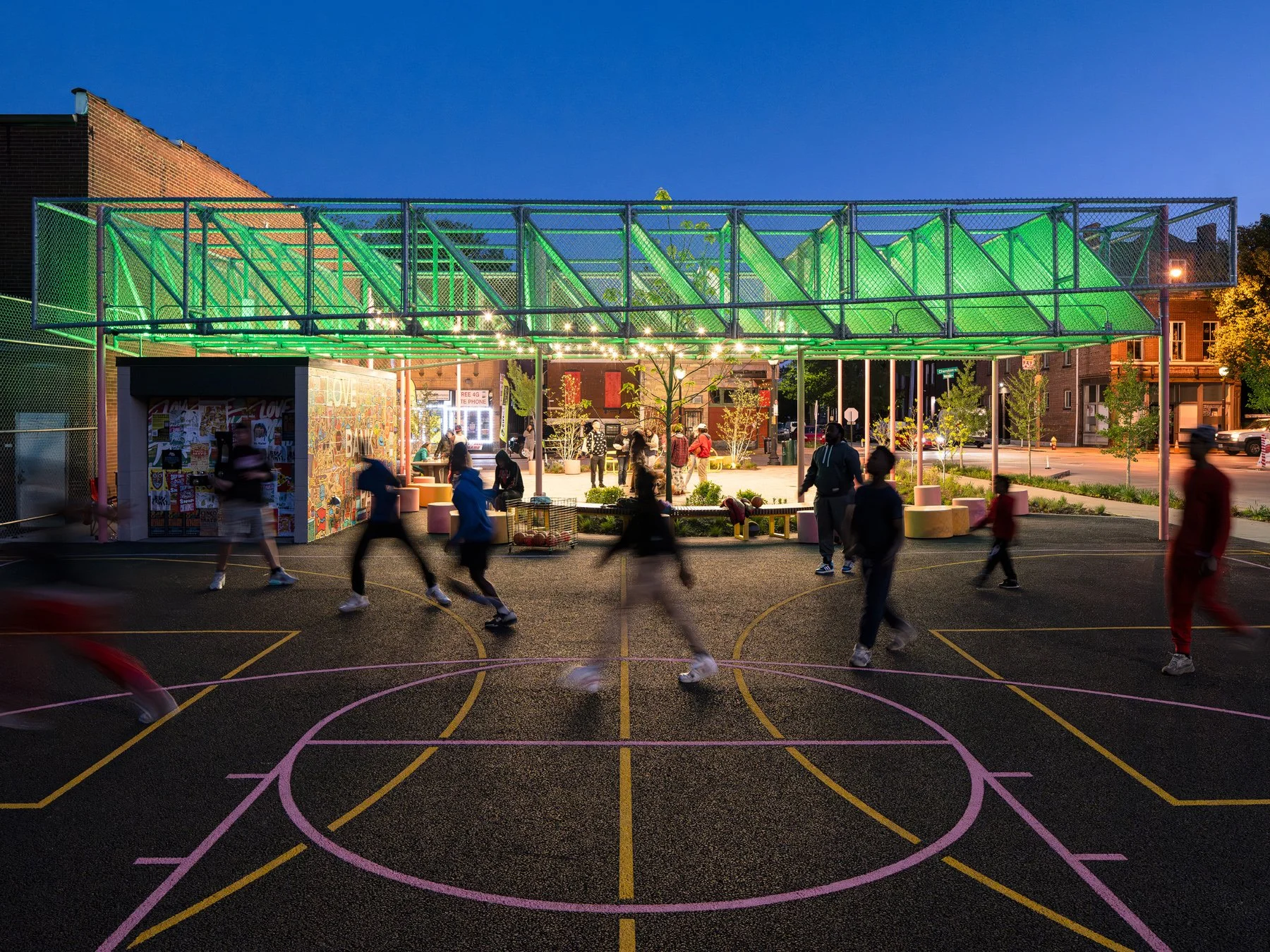 Love Bank Park shade canopy glowing green at night above the basketball court, by Patterhn Ives - architectural photographer St. Louis Missouri