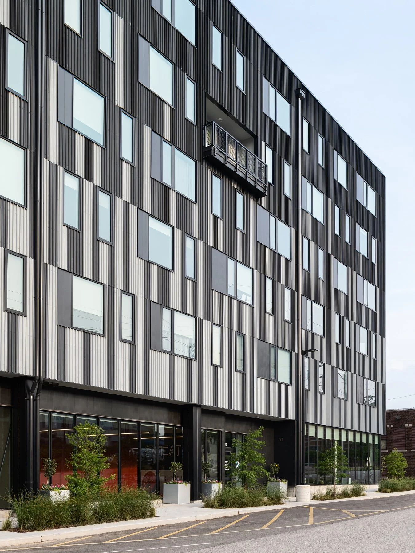 Steelcote Flats corrugated facade with a recessed balcony above ground-floor retail, by Trivers - architectural photographer St. Louis Missouri