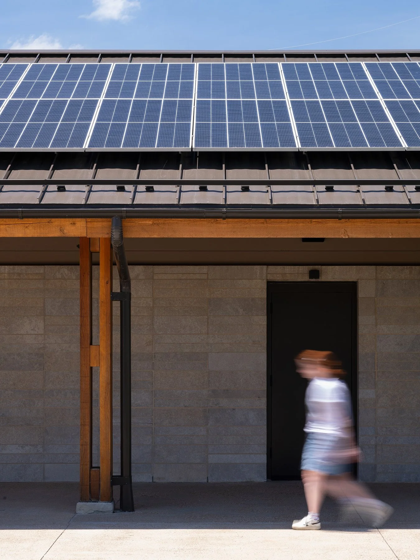 Brentwood Park Event Pavilion solar array close-up above split-face masonry wall, by Christner - architectural photographer St. Louis Missouri