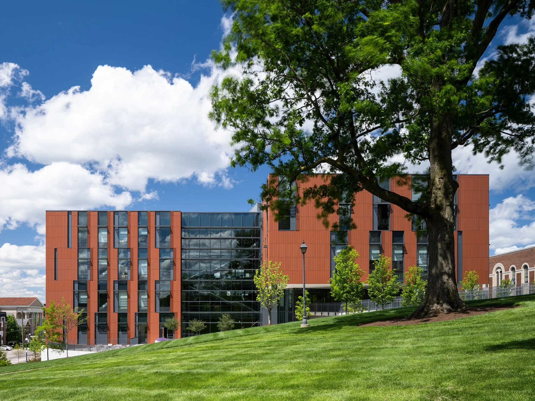 Clifton Court Hall terracotta corner volume seen across the campus lawn, by LMN Architects and KZF Design - architectural photographer Cincinnati Ohio