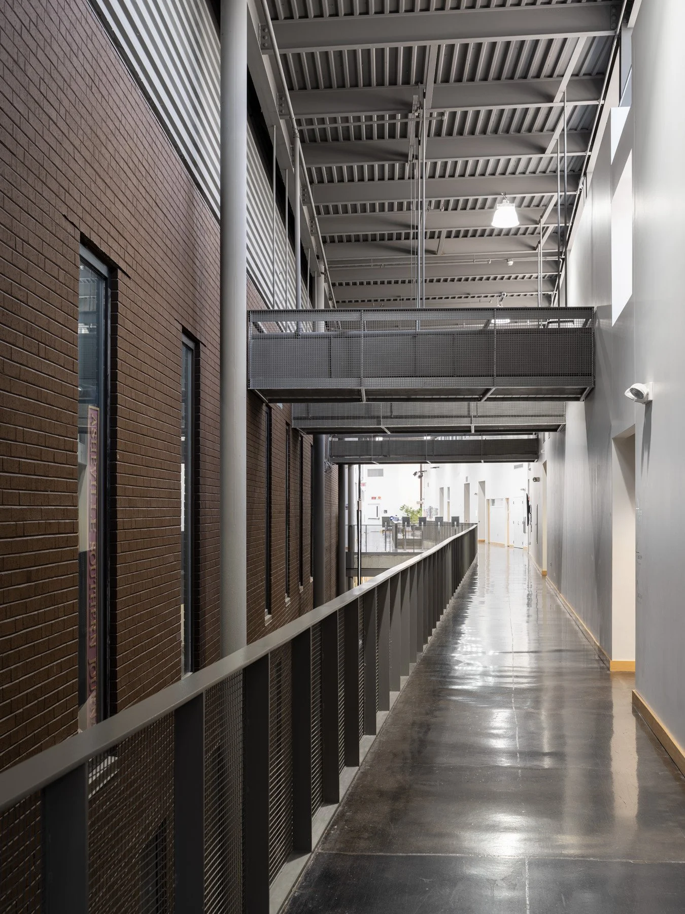 Doudna Fine Arts Center interior brick corridor with steel catwalk and polished concrete ramp by Antoine Predock, Charleston Illinois - architectural photographer
