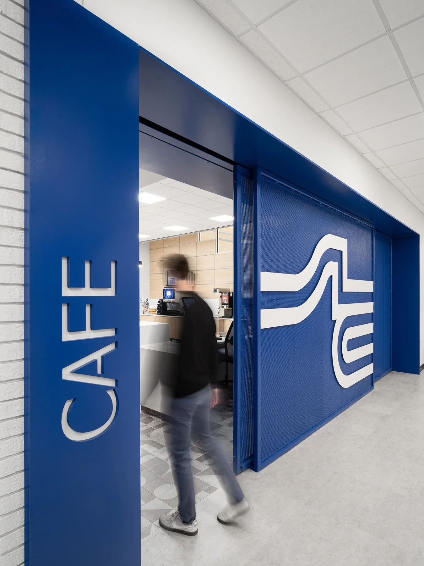 STLCC Florissant Valley Student Center blue cafe entry with perforated logo panel by JEMA, Ferguson Missouri - architectural photographer St. Louis