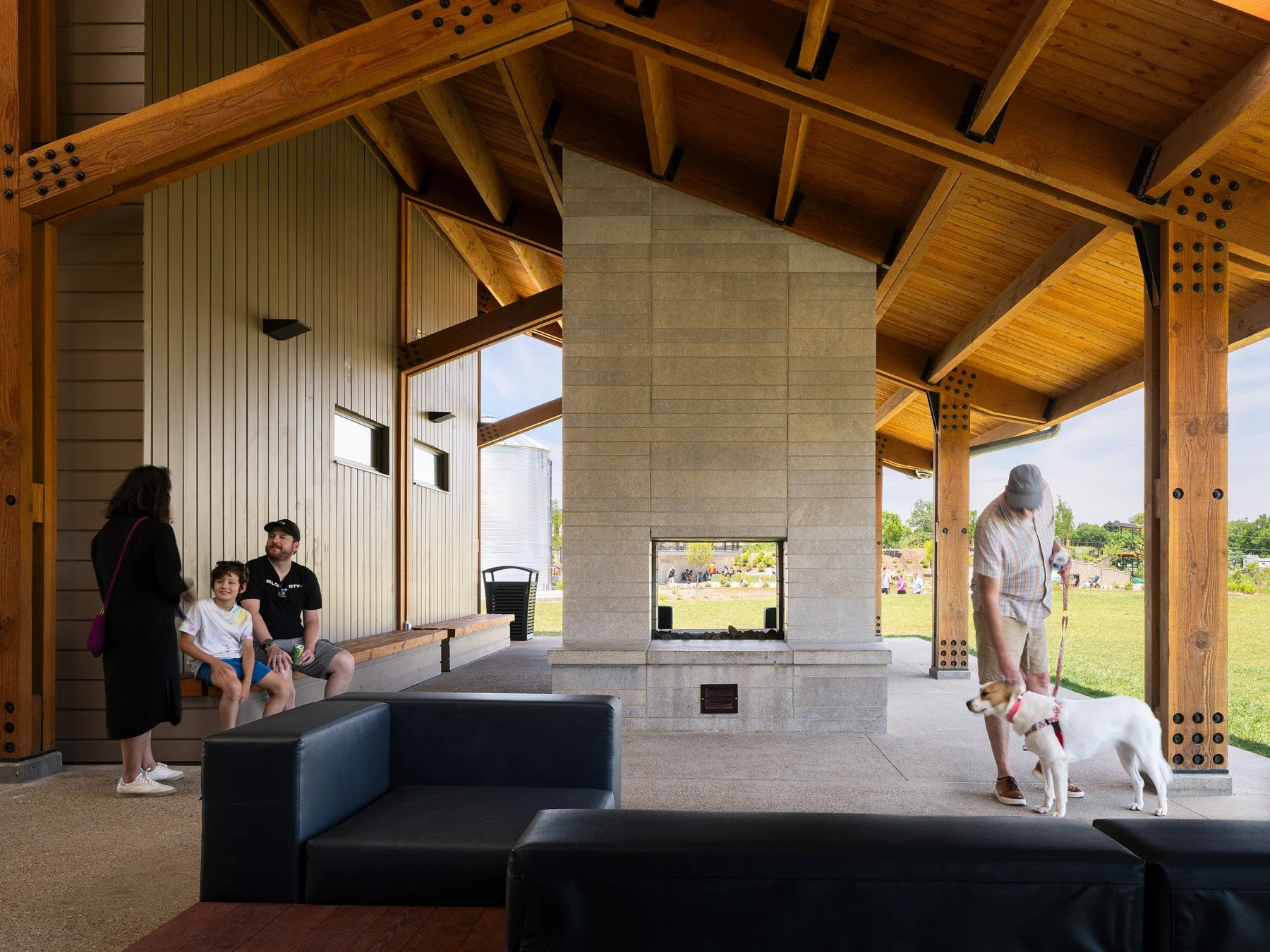 Brentwood Park Event Pavilion outdoor fireplace terrace under timber gable with view to event lawn, by Christner - architectural photographer St. Louis Missouri