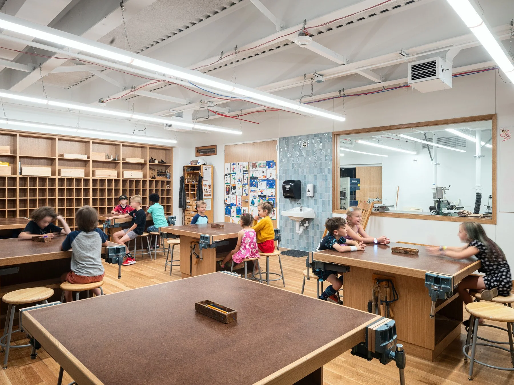 Broughton STEAM Center interior woodworking classroom with vises and storage cubbies, by Christner - architectural photographer St. Louis Missouri