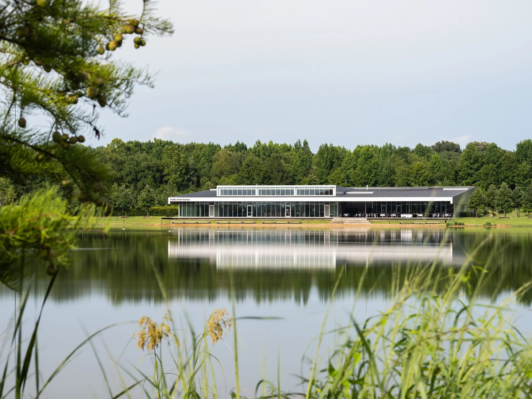 Shelby Farms Park glass event center reflected across the lake, by Marlon Blackwell Architects - architectural photographer Memphis Tennessee
