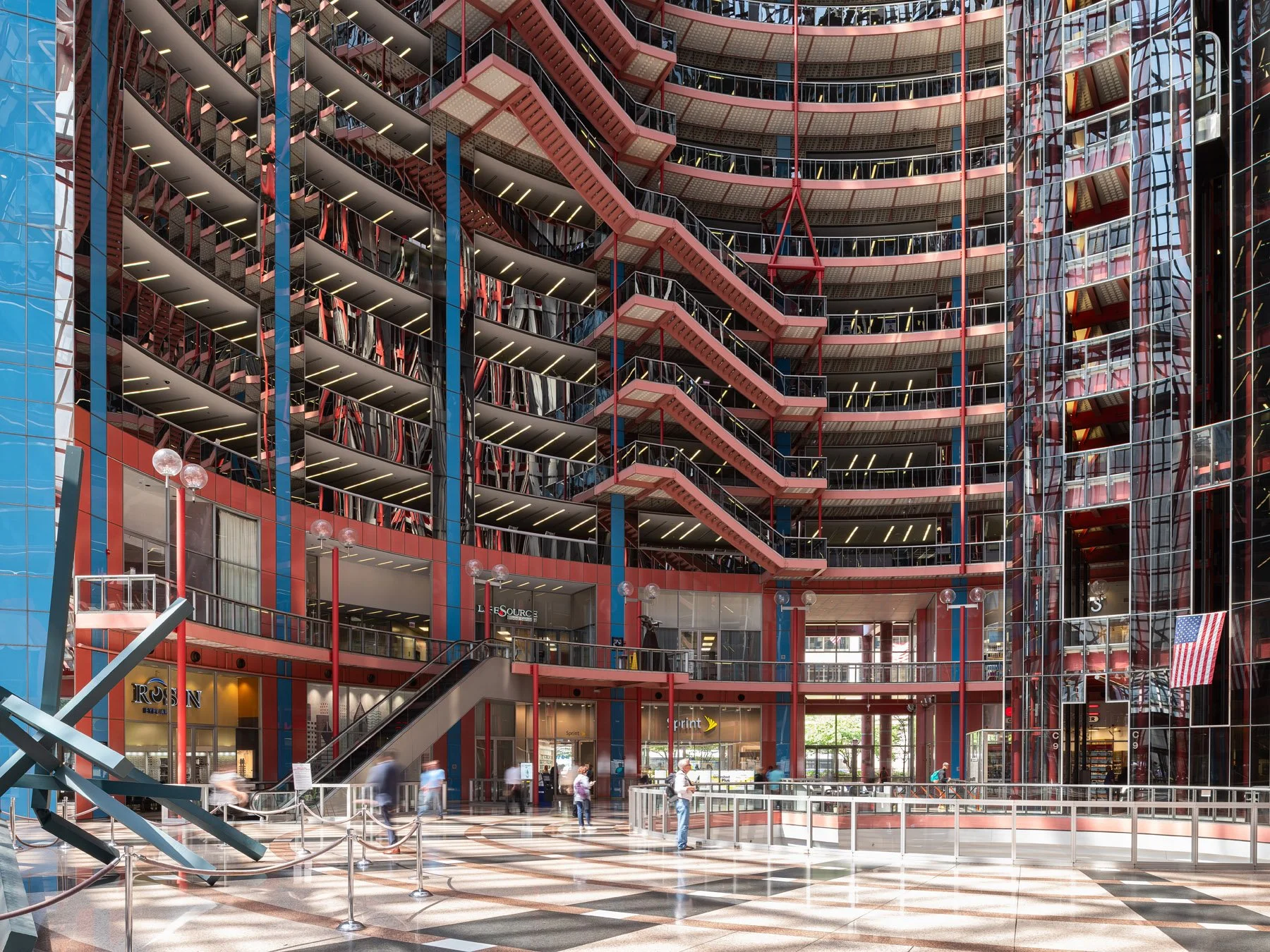 James R. Thompson Center atrium, curving office tiers in salmon and blue around the mirrored core, Chicago - before renovation interior