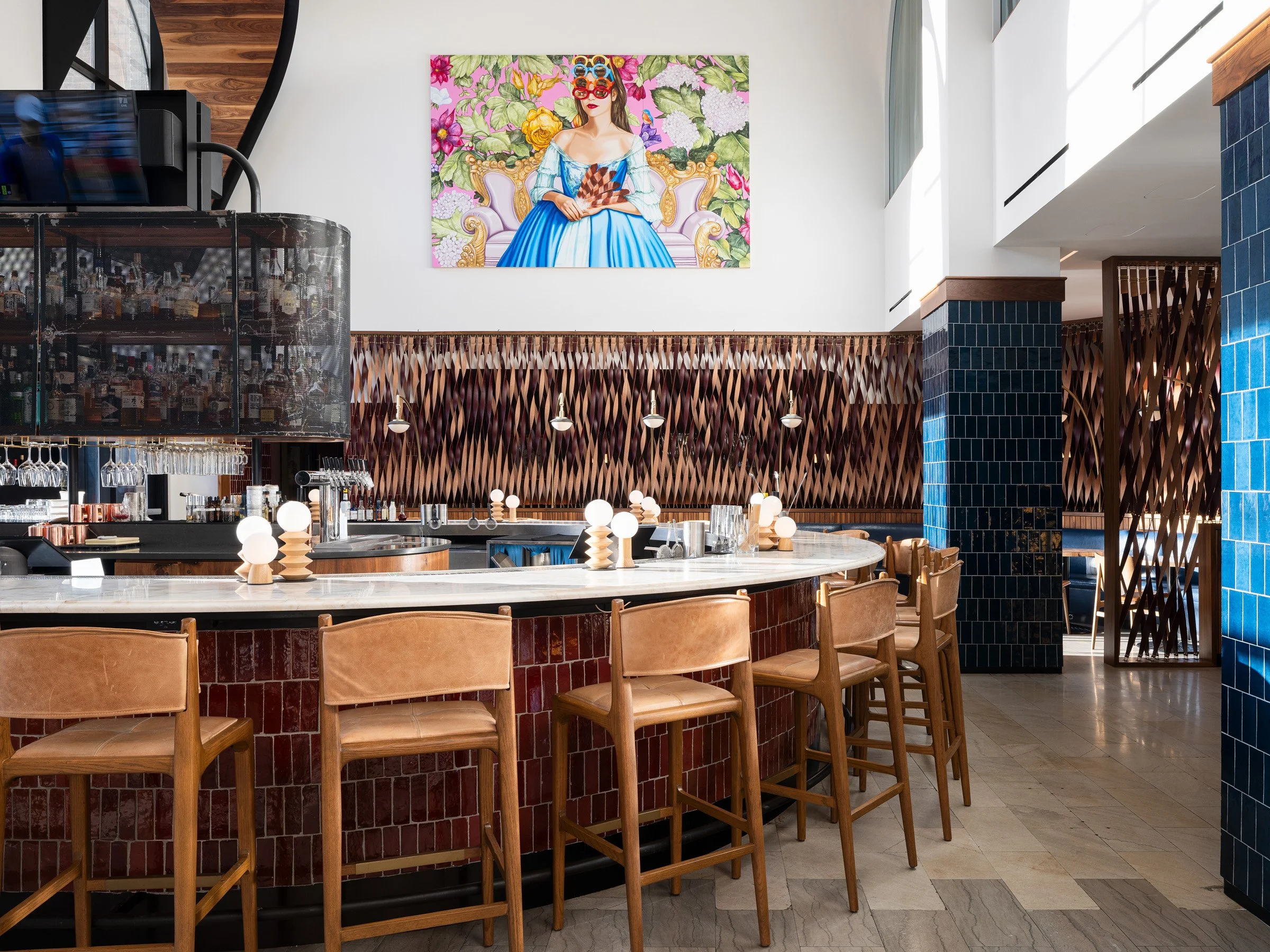 Idol Wolf restaurant interior bar with a curved marble counter on a red tile base and a large pop portrait painting above, at the 21c Museum Hotel by Perfido Weiskopf Wagstaff + Goettel and Hufft - architectural photographer St. Louis Missouri