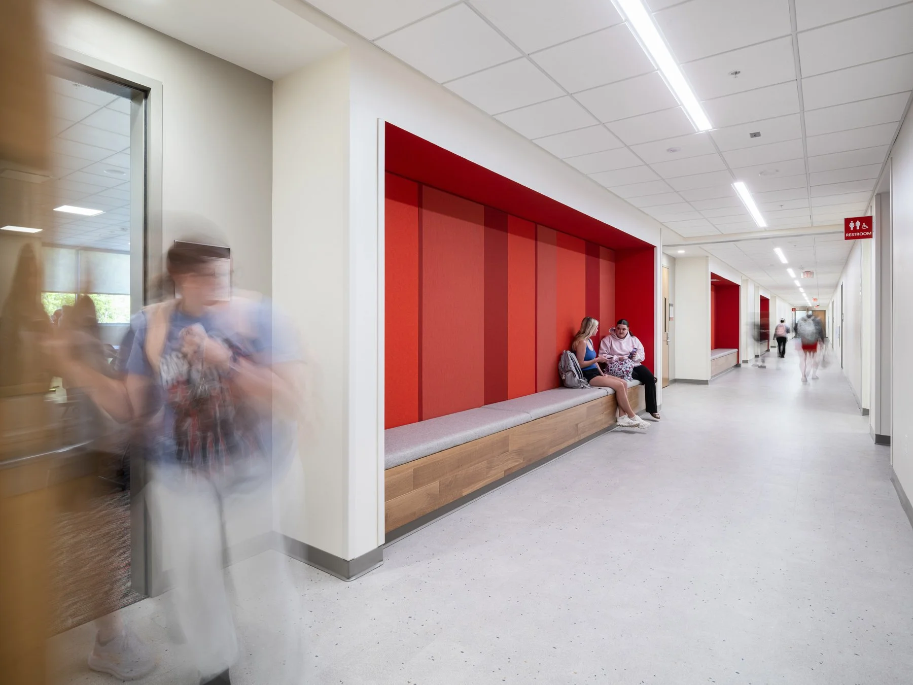 SIUE Health Sciences corridor with a recessed red felt niche and wood bench by Christner, Edwardsville Illinois - architectural photographer St. Louis