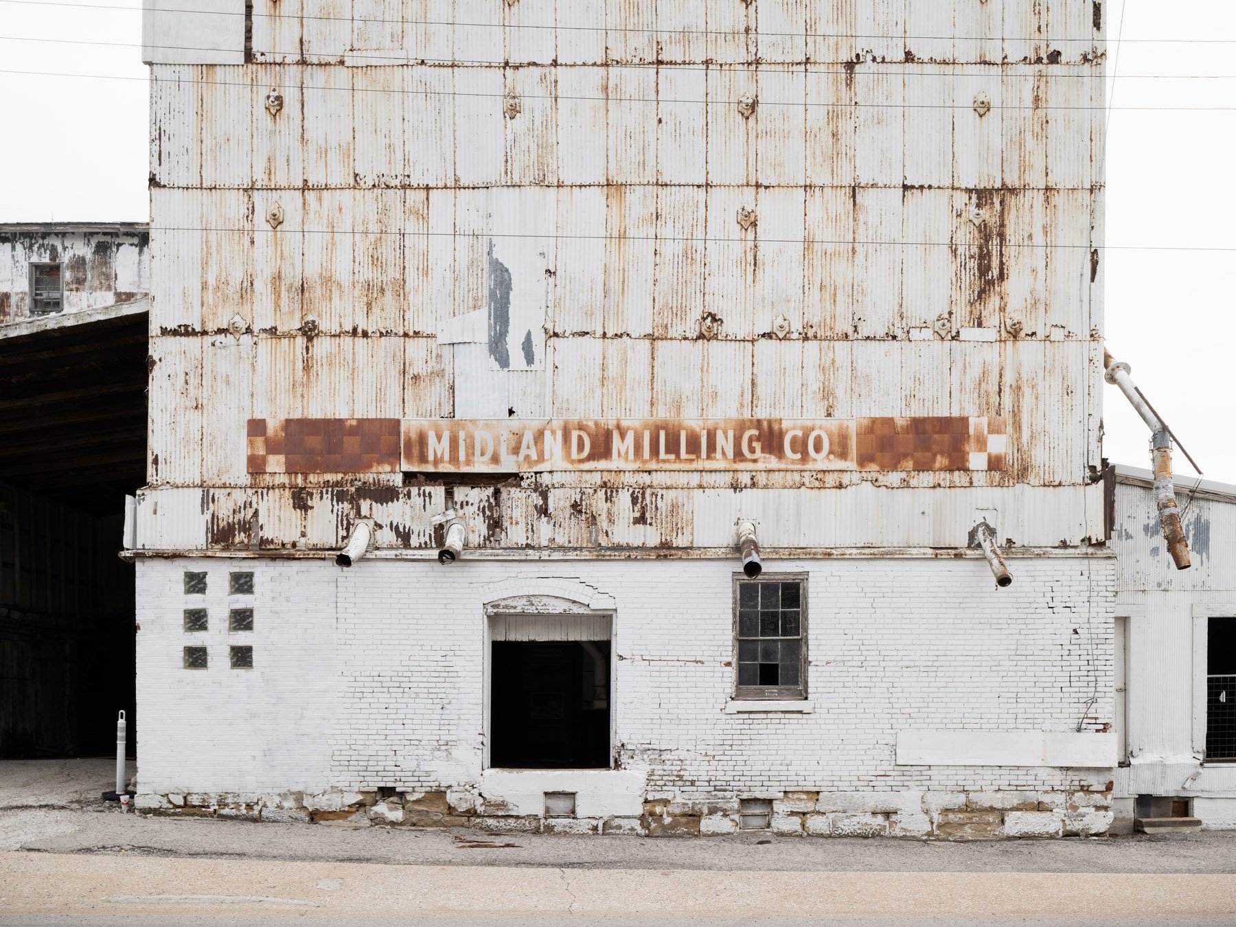 Millstadt Mill east tower with the painted MIDLAND MILLING CO ghost sign over whitewashed brick - architectural photographer St. Louis Missouri