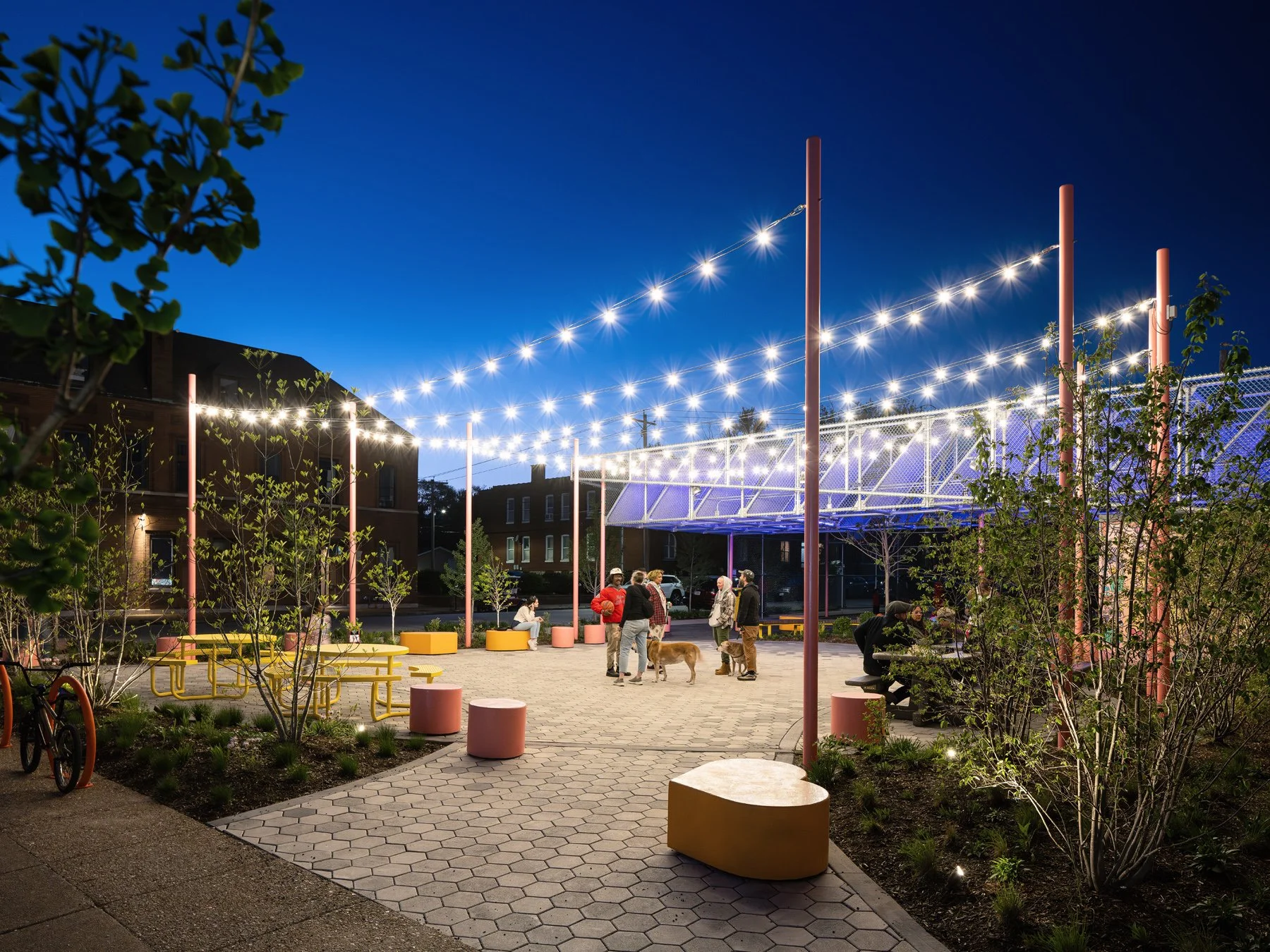 Love Bank Park string lights over the plaza at dusk, by Patterhn Ives and Arbolope Studio - architectural photographer St. Louis Missouri
