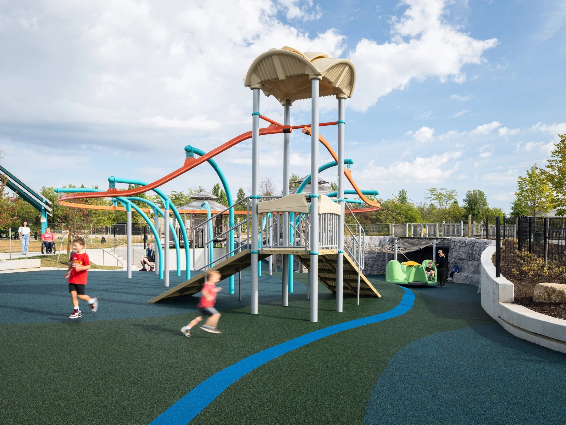 Kinetic Park play tower and looping overhead track on rubber surfacing, landscape by DG2 Design - architectural photographer St. Louis Missouri