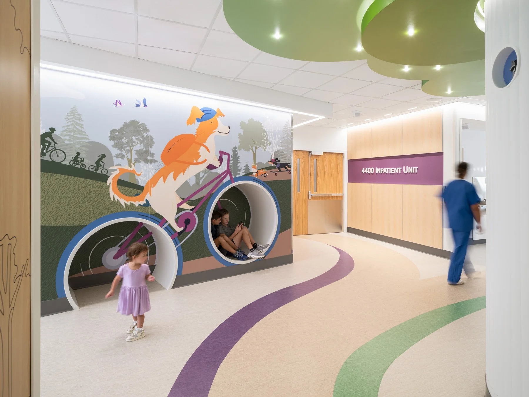 St. Louis Children’s Hospital corridor mural of a dog on a bike with nook seating, by CannonDesign - architectural photographer St. Louis Missouri