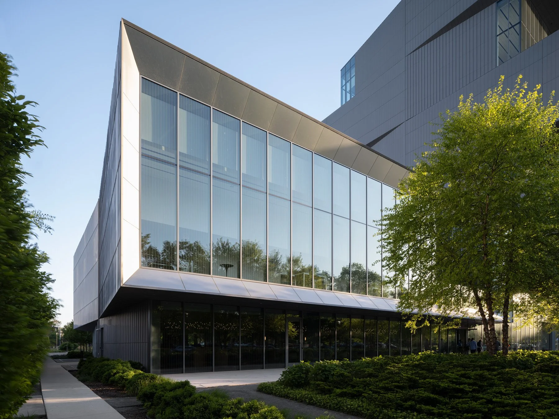 David Rubenstein Forum exterior, angled glass wall of the two-story base by Diller Scofidio + Renfro - architectural photographer Chicago Illinois