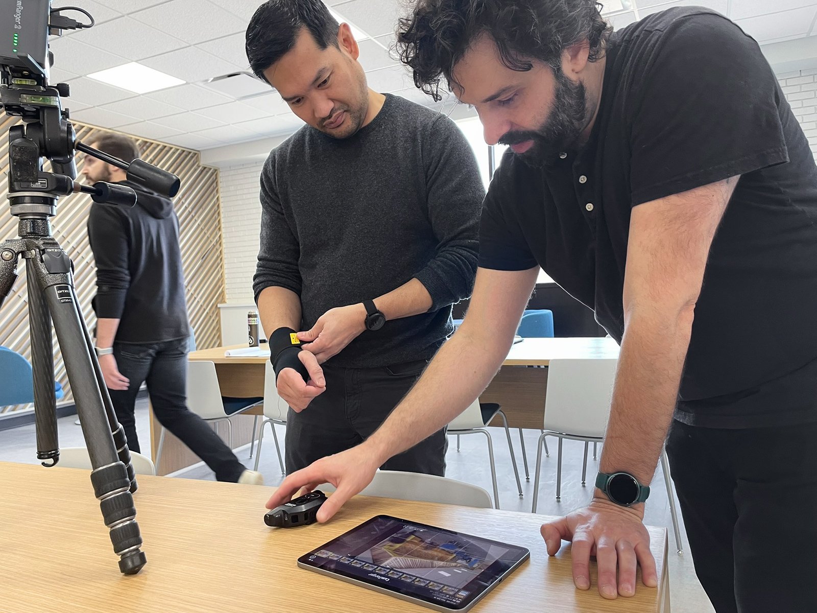 Architectural photographer Serhii Chrucky reviewing tethered captures on a tablet with a client during an interior shoot, medium format camera and tripod alongside.