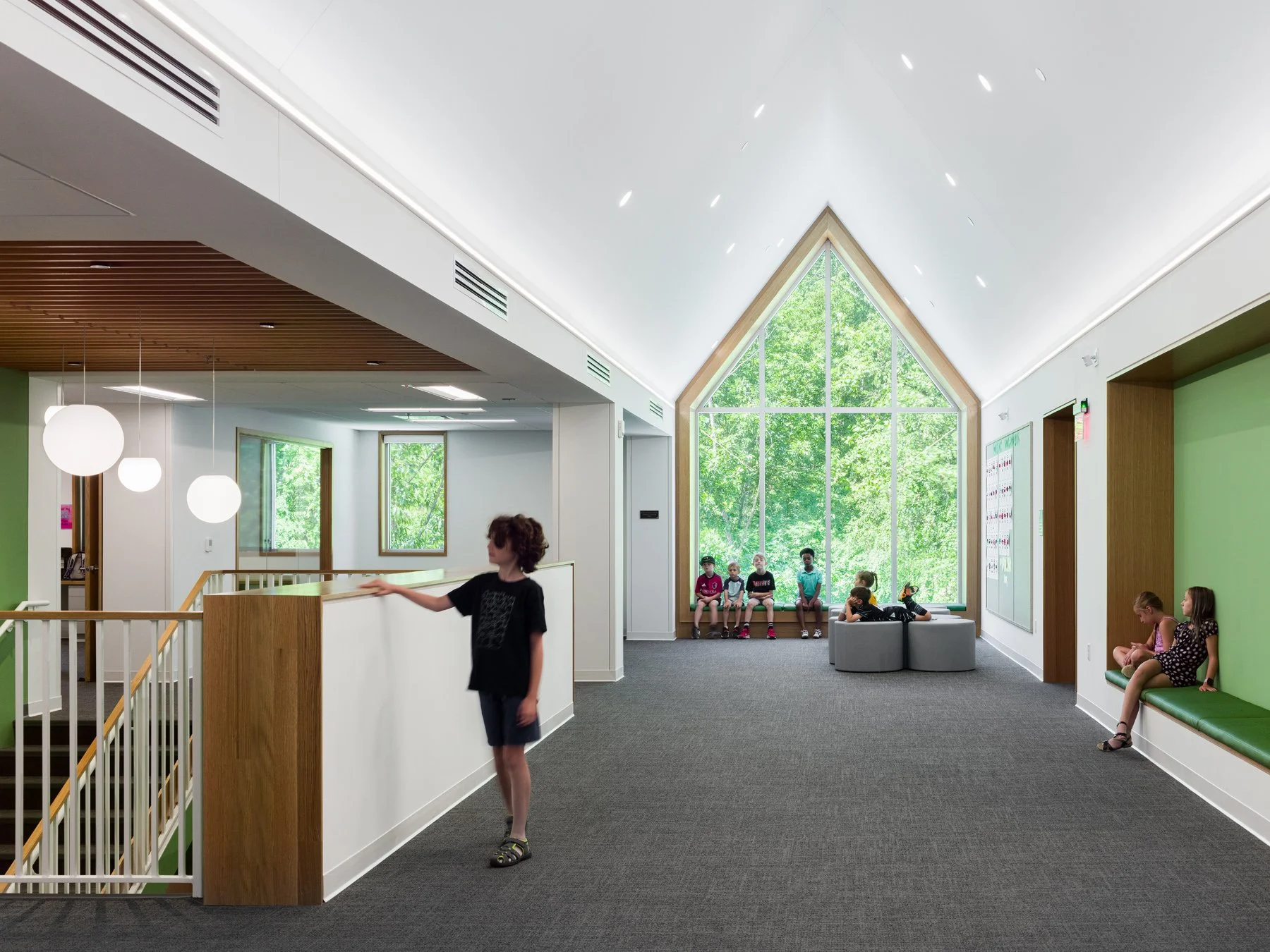 Broughton STEAM Center interior vaulted commons with peaked window ending the corridor, by Christner - architectural photographer St. Louis Missouri
