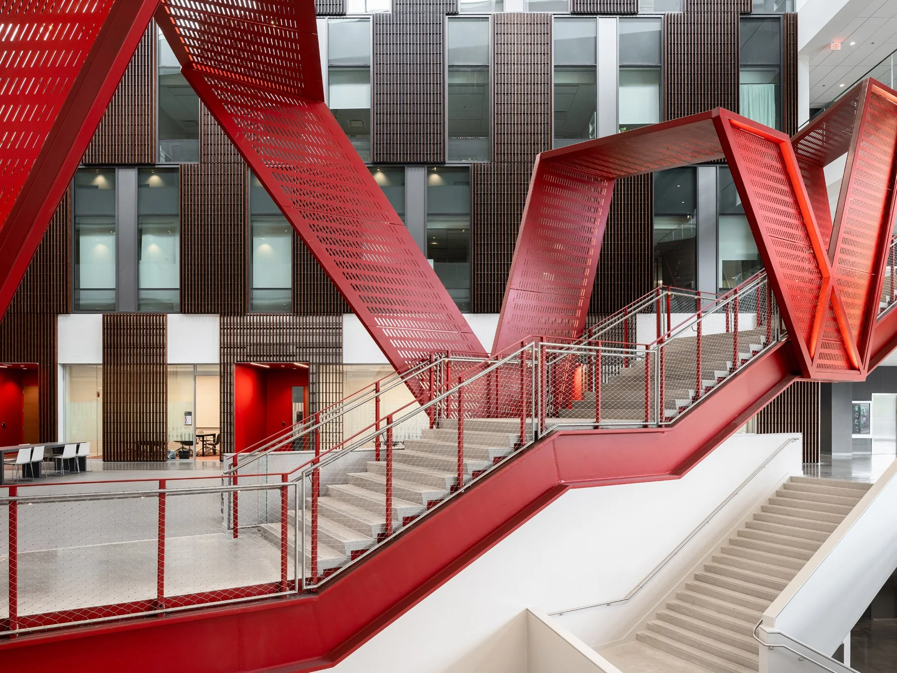 Clifton Court Hall red perforated steel stair detail against the office facade, by LMN Architects and KZF Design - architectural photographer Cincinnati Ohio