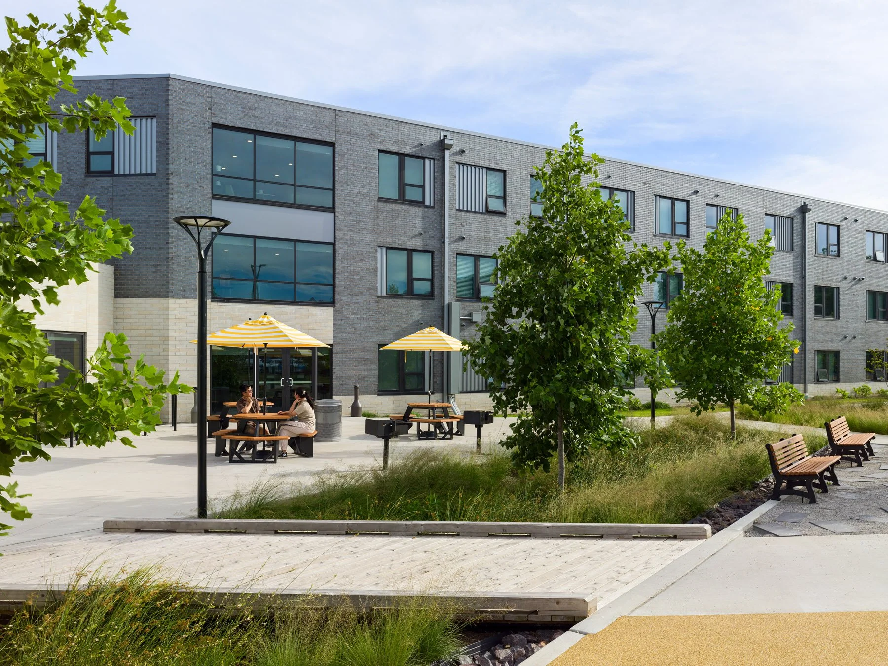 DOORWAYS housing wing facade with courtyard picnic area, by Trivers - architectural photographer St. Louis Missouri