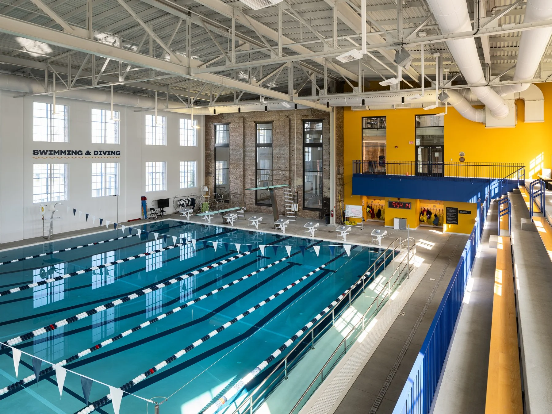 Beloit College Powerhouse competition pool and diving boards below original brick walls, by Studio Gang - architectural photographer Beloit Wisconsin