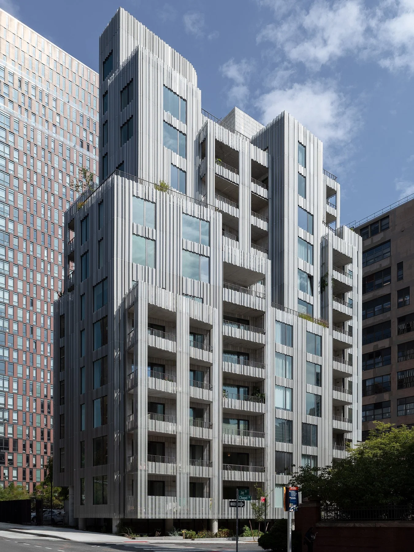 9 Chapel full corner exterior with tall undulating aluminum fins, recessed balconies, and glazed openings, by SO–IL - architectural photographer New York