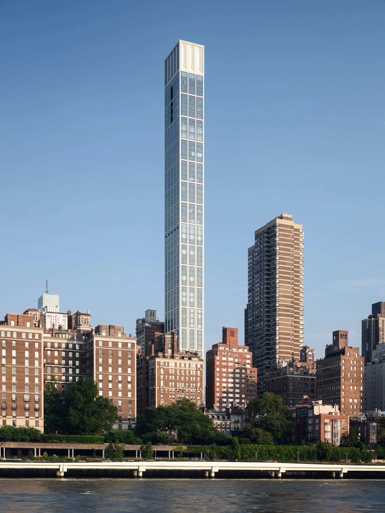 Sutton Tower slender limestone shaft rising above East River skyline, by Thomas Juul-Hansen, New York New York - architectural photographer New York
