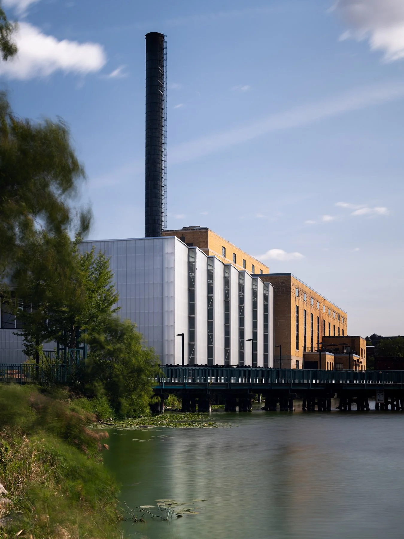 Beloit College Powerhouse smokestack rising above the field house by the Rock River, by Studio Gang - architectural photographer Beloit Wisconsin