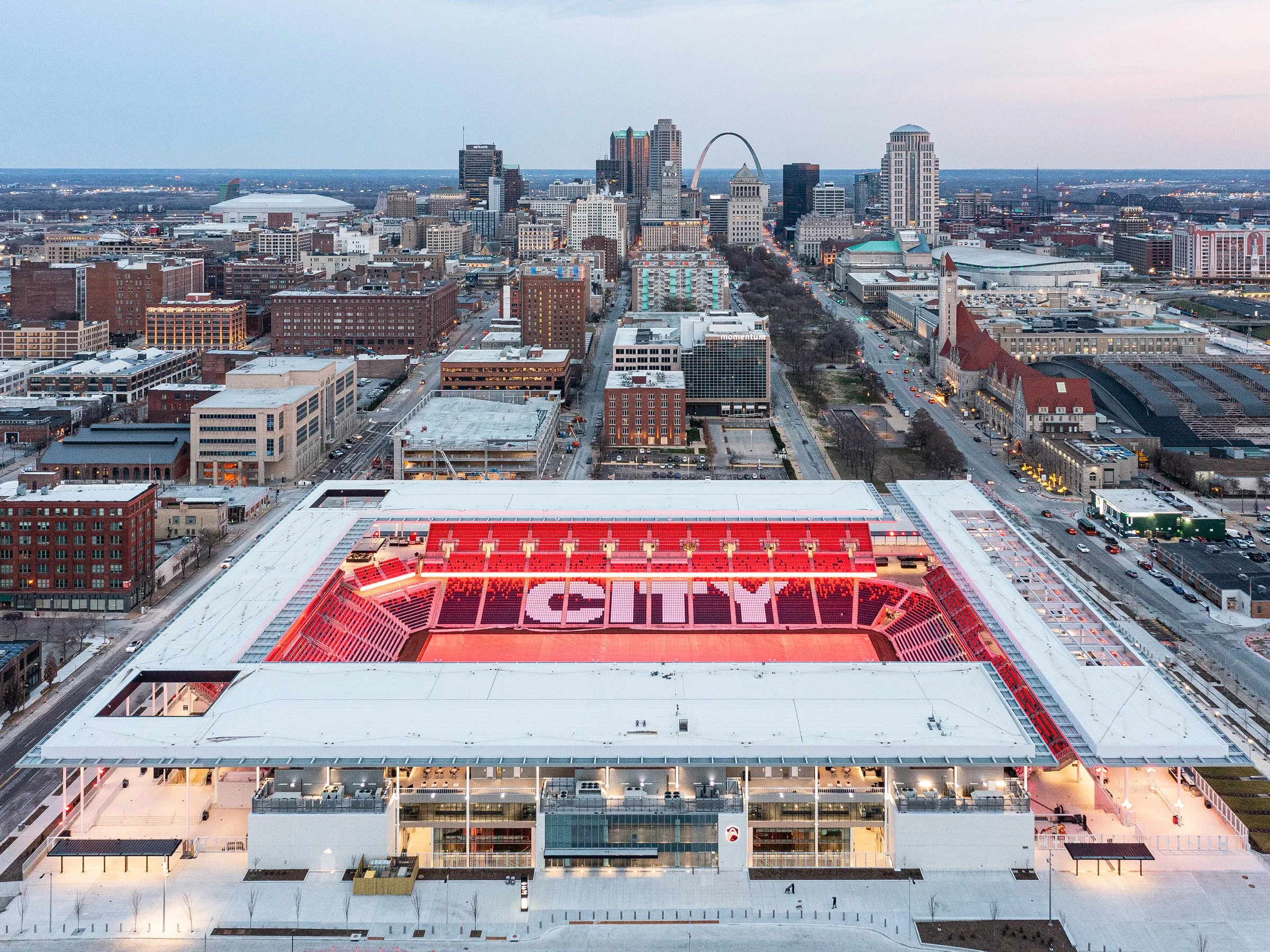 Aerial view of Energizer Park stadium at dusk, looking towards downtown St. Louis.
