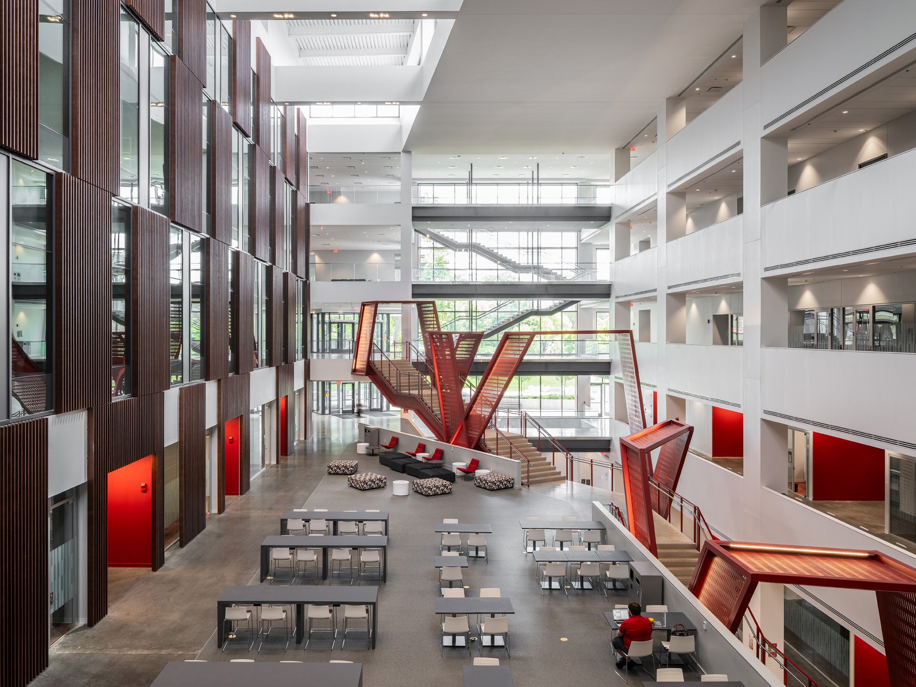 Clifton Court Hall five-story atrium with sculptural red stair and seating areas, by LMN Architects and KZF Design - architectural photographer Cincinnati Ohio