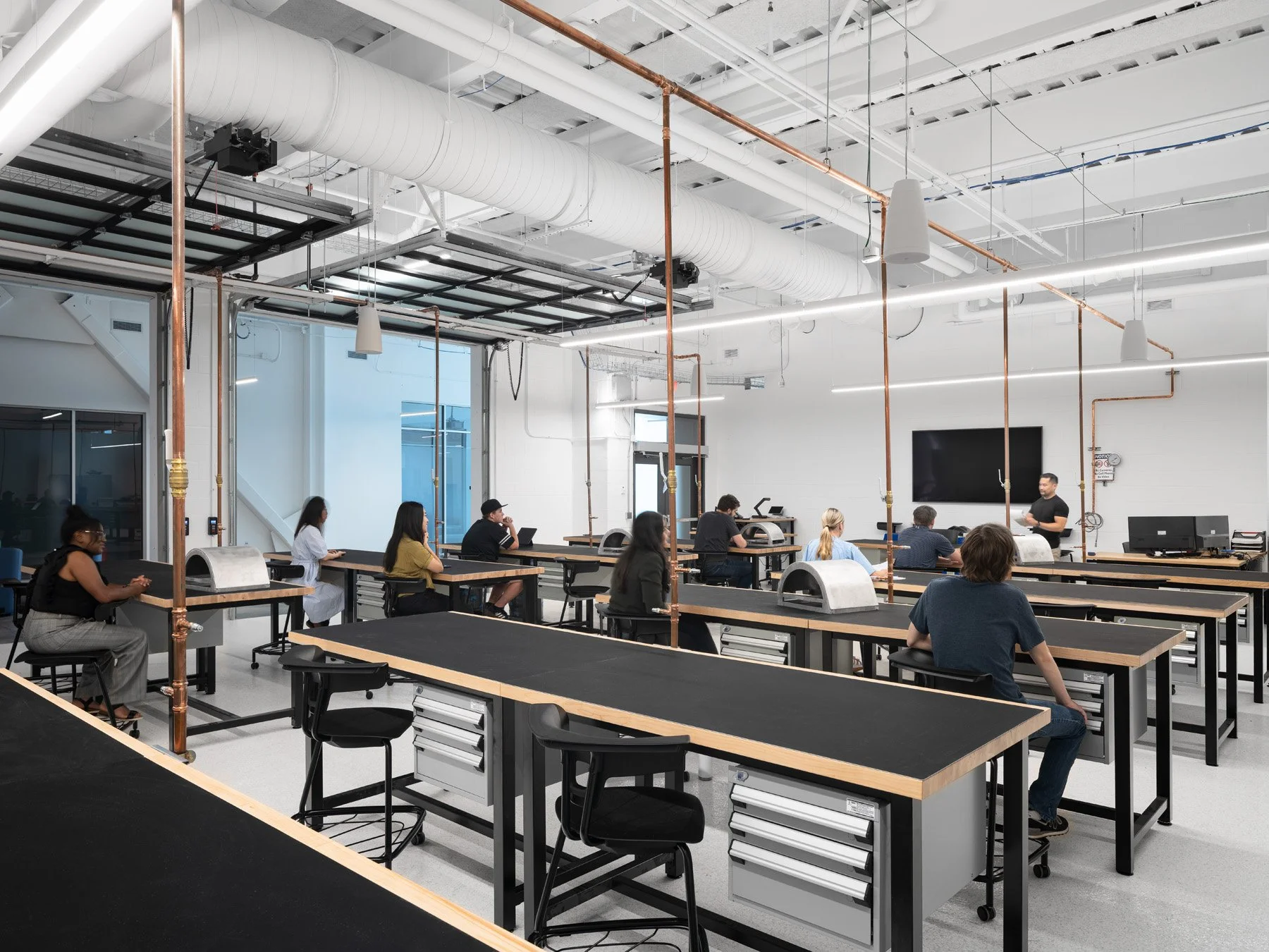 STLCC Florissant Valley Advanced Manufacturing Center lab benches under copper piping by JEMA - architectural photographer St. Louis Missouri