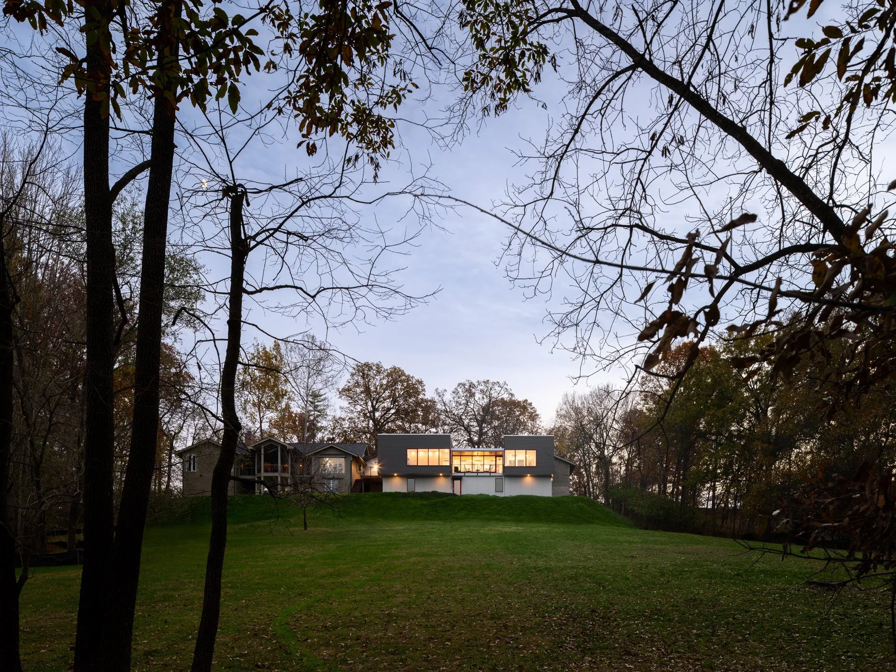 Monty Residence exterior at dusk showing the addition beside the existing house, by Studio Lark - architectural photographer St. Louis Missouri
