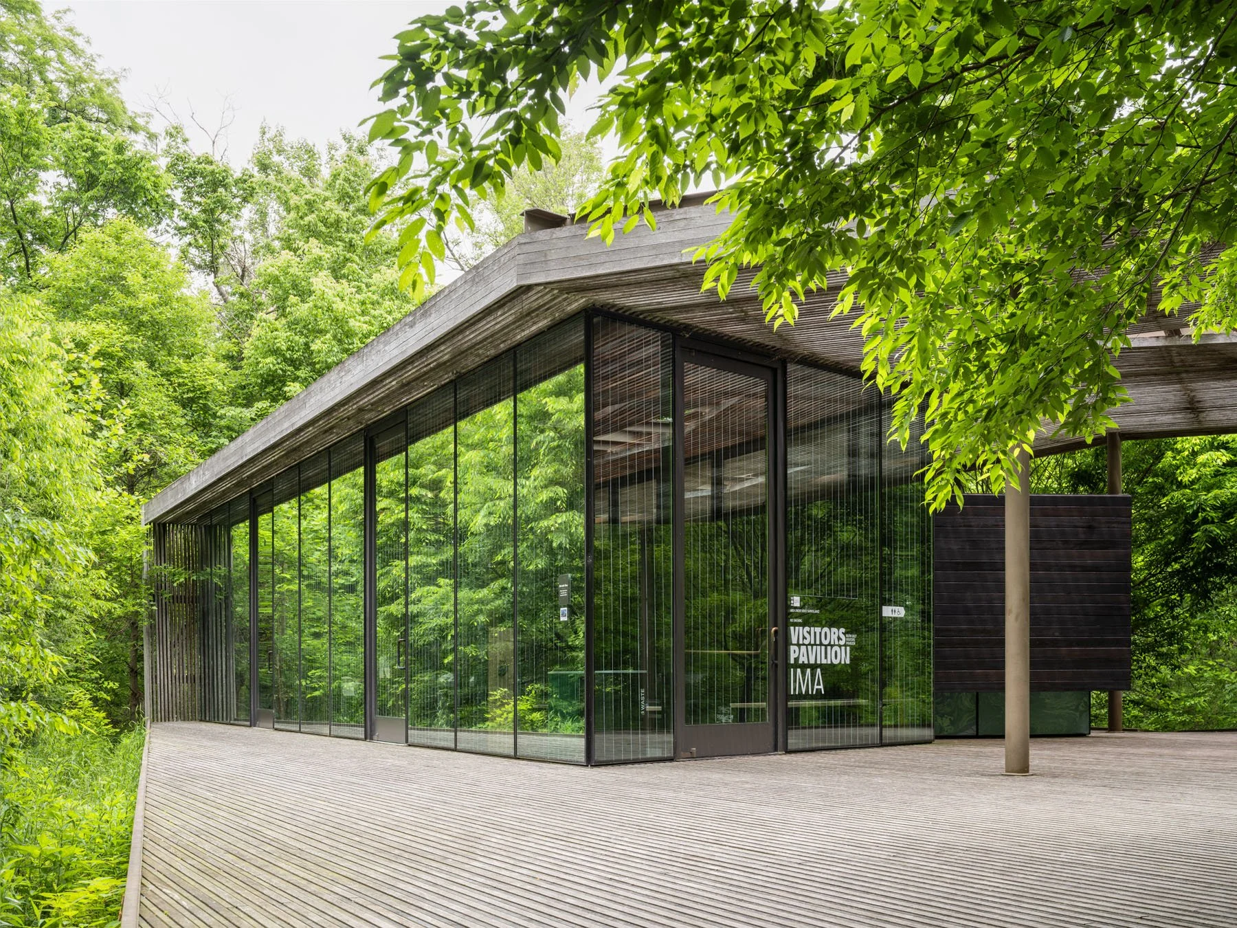 Ruth Lilly Visitors Pavilion glass curtainwall corner with slatted canopy overhang and surrounding forest, by Marlon Blackwell Architects, Indianapolis Indiana - architectural photographer