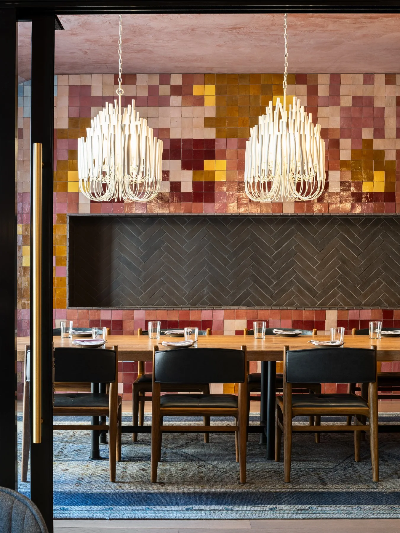 Idol Wolf restaurant interior dining room with a wall of red and gold mosaic tile and branching white chandeliers, at the 21c Museum Hotel by Perfido Weiskopf Wagstaff + Goettel and Hufft - architectural photographer St. Louis Missouri