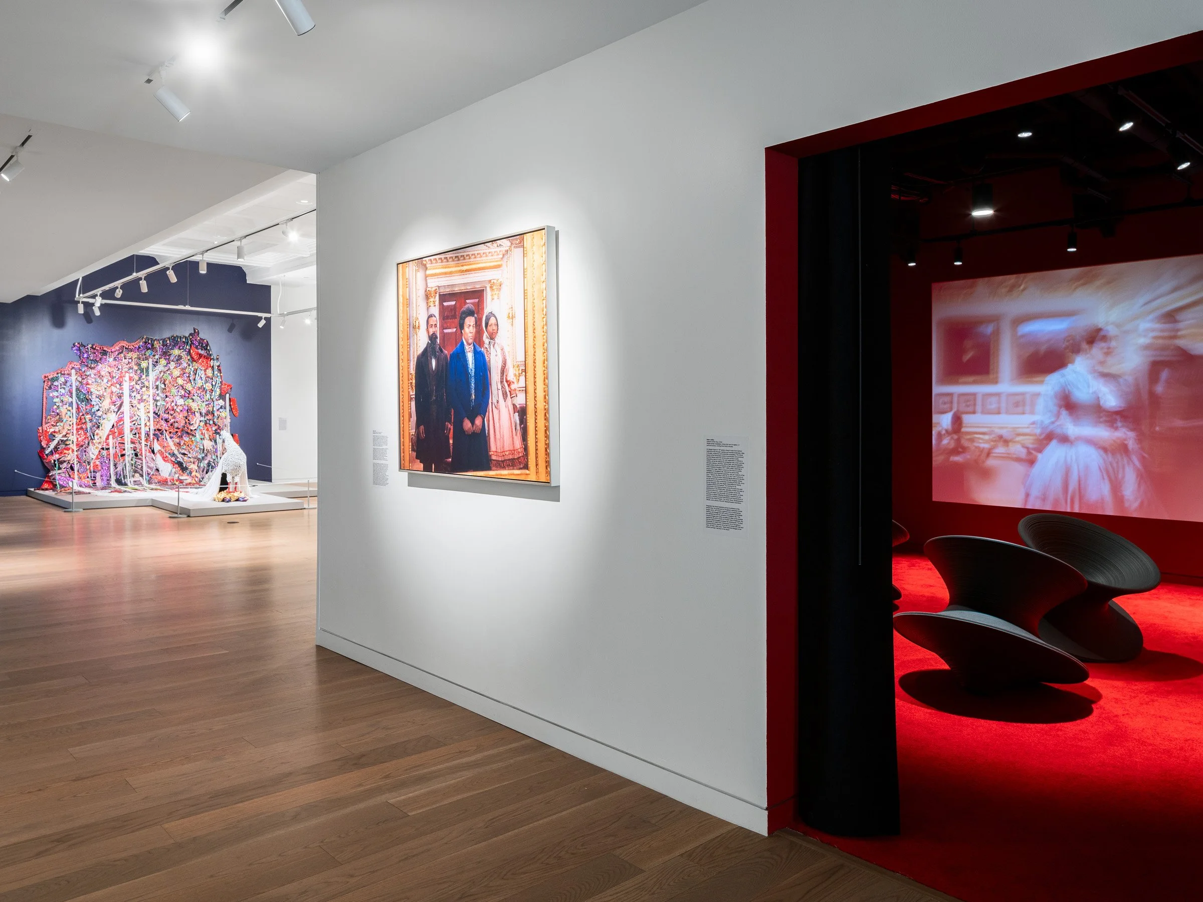 21c Museum Hotel interior contemporary art gallery with a framed photographic portrait and a red projection room, a publicly accessible museum by Perfido Weiskopf Wagstaff + Goettel and Hufft - architectural photographer St. Louis Missouri