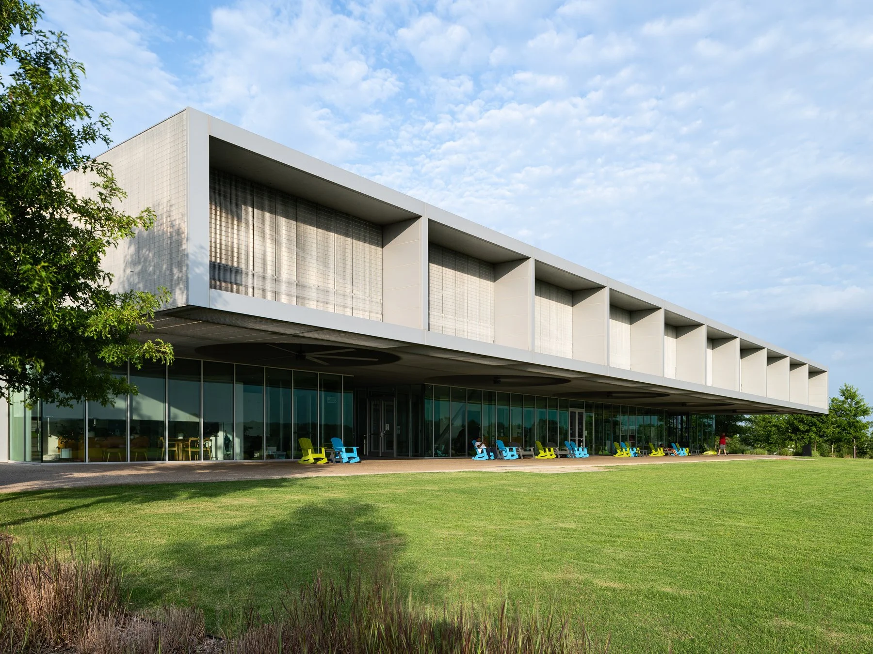 Shelby Farms Park visitor center glass porch with colorful chairs, by Marlon Blackwell Architects - architectural photographer Memphis Tennessee