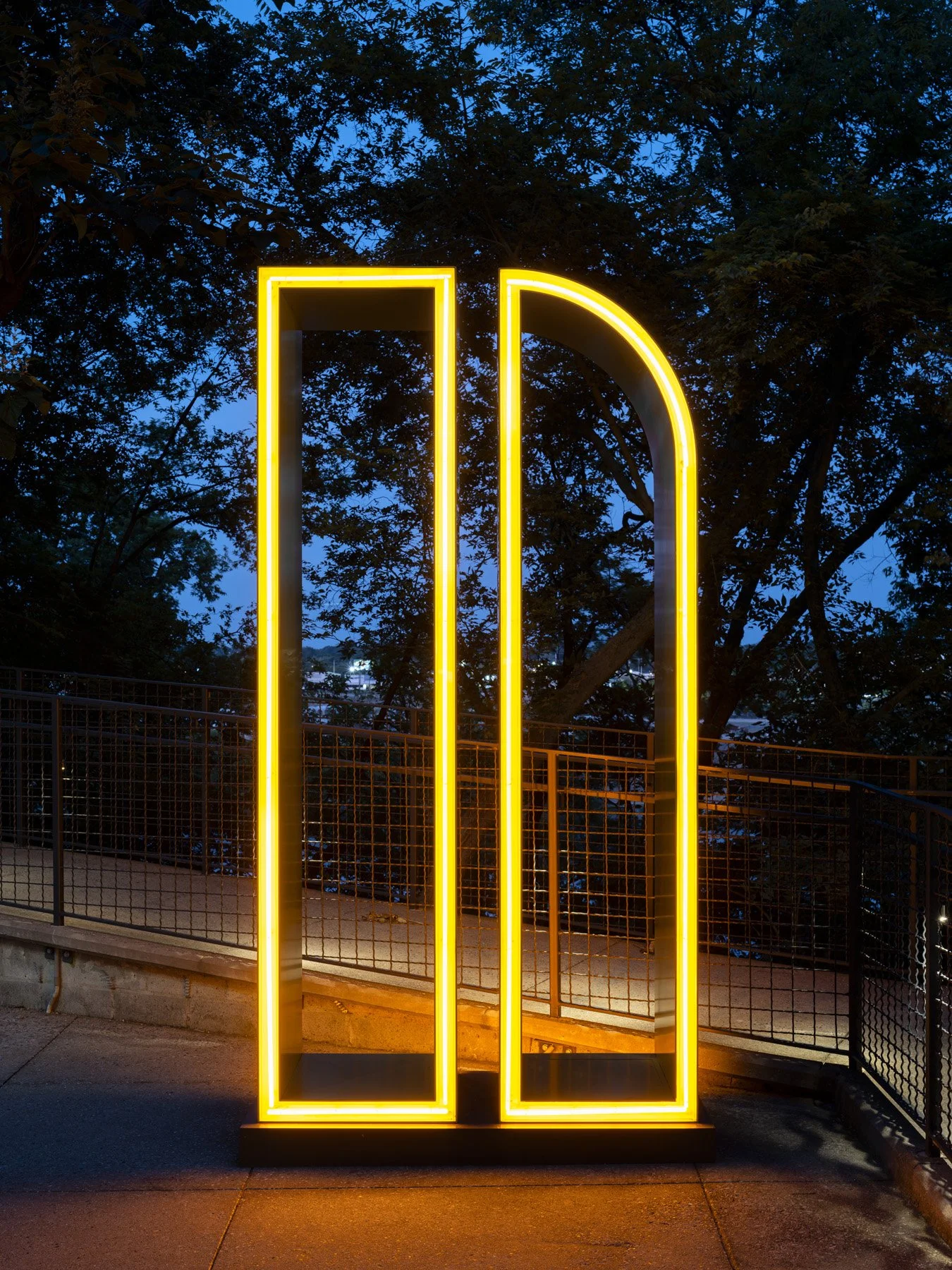 Neuhoff District illuminated letter n sculpture at dusk on a walkway, signage by Airspace - architectural photographer Nashville Tennessee